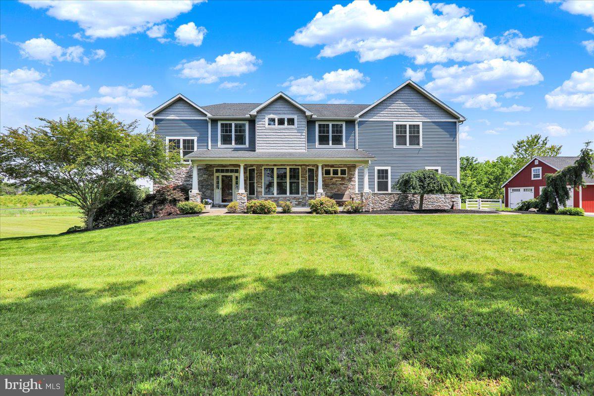 Welcome to 1650 Wolford Rd, a thoughtfully designed custom home situated on over 5 scenic acres. From the moment you arrive, the setting offers a sense of peace and privacy - with a large, stocked pond  and a covered rear patio that overlooks it beautifully.

Inside, the home offers 5 bedrooms, 5 full bathrooms and a half bathroom, including two main suites on the second floor. The primary suite features a spa-inspired bathroom with heated flooring, a soaking tub, a walk-in shower, and two walk-in closets. The second suite includes its own walk-in closet with direct access to the upstairs laundry room for added convenience. Every bedroom has access to a full bath, making this home ideal for families or guests.

The main level includes an office, a walk-in pantry off the kitchen, and a cozy pellet stove fireplace. French doors lead from the main living space to the rear patio, seamlessly blending indoor comfort with outdoor relaxation.

Downstairs, the finished walkout basement is filled with natural light and includes a full bathroom and wet bar—perfect for entertaining, guests, or extended living space.

In addition to the attached 3-car garage, there’s also a detached 2-car garage, offering plenty of storage or workshop potential. Dual-zone HVAC systems provide efficient comfort throughout the home, and an instant water heater serves the primary bathroom.

With quality finishes, a smart layout, and an unbeatable outdoor setting, this home is a rare find. Schedule your private tour today.