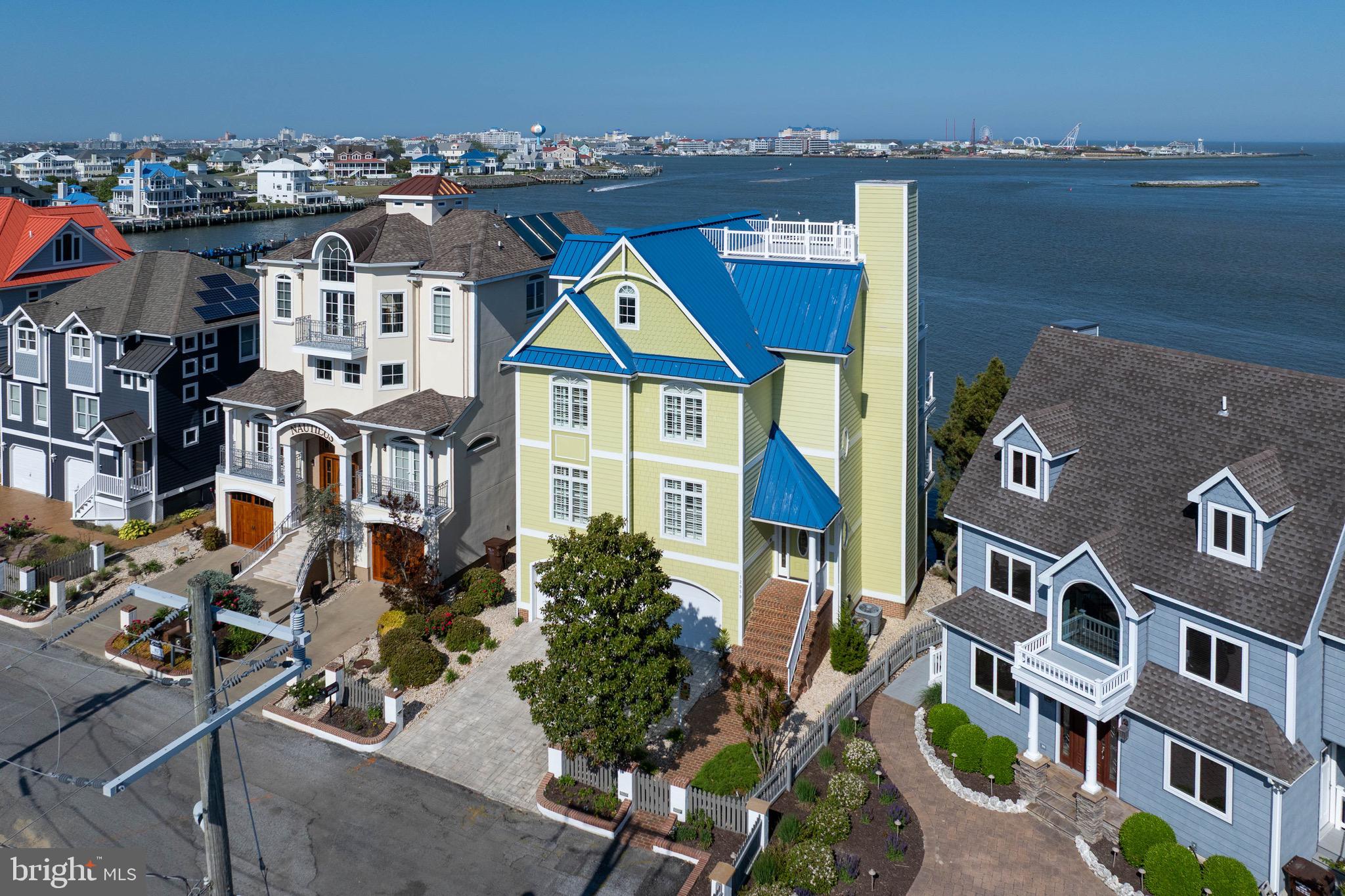 If real estate truly comes down to location, this West Ocean City setting is difficult to top.

With expansive water views, direct boating access, and a front-row perspective of the inlet, Assateague, and the Ocean City skyline, this 4-bedroom, 4-bath home stands out in one of the region’s most desirable coastal locations.

Custom built in 2003 and designed to capture the full impact of its surroundings, the home features breathtaking views from multiple levels, an open kitchen and living area wrapped in glass, generous bedroom spaces, two fireplaces, and an elevator serving every level, including the rooftop deck.

The main living area is the centerpiece of the home, bringing the kitchen, dining, and living spaces together in one bright, open gathering space designed around the water.

The primary suite is a standout of its own, with generous space, beautiful natural light, a perfectly positioned fireplace, and the same incredible water views that define the home. A remarkable custom bathroom and additional walk-in dressing room/closet complete the suite with comfort, function, and style.

The outdoor spaces are just as impressive, with five separate seating areas including covered and uncovered balconies, a waterside deck, and a rooftop deck with sweeping views across the bay, inlet, Assateague, and Ocean City. Whether you are entertaining, relaxing, or watching the boats move through the water, the setting is always part of the experience.

For boating, the property includes two deeded boat slips with lifts, giving you direct and immediate access to the surrounding waterways. The location also places you close to restaurants, marinas, beaches, shopping, entertainment, and the best of coastal Maryland.

This is a rare opportunity to own an exceptional waterfront home in one of West Ocean City’s most memorable and hard-to-duplicate locations.