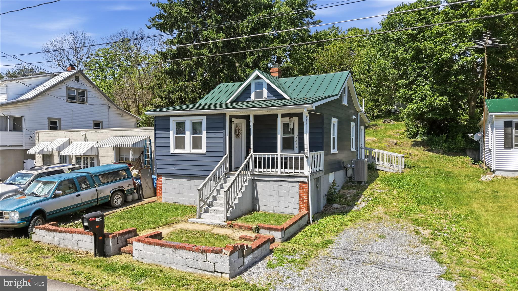 This wonderful cape cod is so charming with its  covered, front porch, and it's located just outside Winchester city limits, yet before you get to the Sunnyside shopping area.   It's tucked away in a community away from the hustle and bustle of town, and yet easy access to commuter routes.  Remodeled in 2023, and then further improved. Recent upgrades include a new metal roof, vapor barrier, new electrical panel, new water heater and a washer and dryer.  The primary bedroom is located on the main floor.  You'll also find an updated kitchen with stainless steel appliances, to include a dishwasher, built in microwave and granite counter tops.  There's ample table space in the kitchen.  The living room if bright and airy.  LVP flooring throughout the main level.  Check out the awesome mud room!  Upstairs, you'll find an attic that spans the width of the house.  It's set up as a guest bedroom at the moment! Excuse the boxes as the seller packs up for moving.