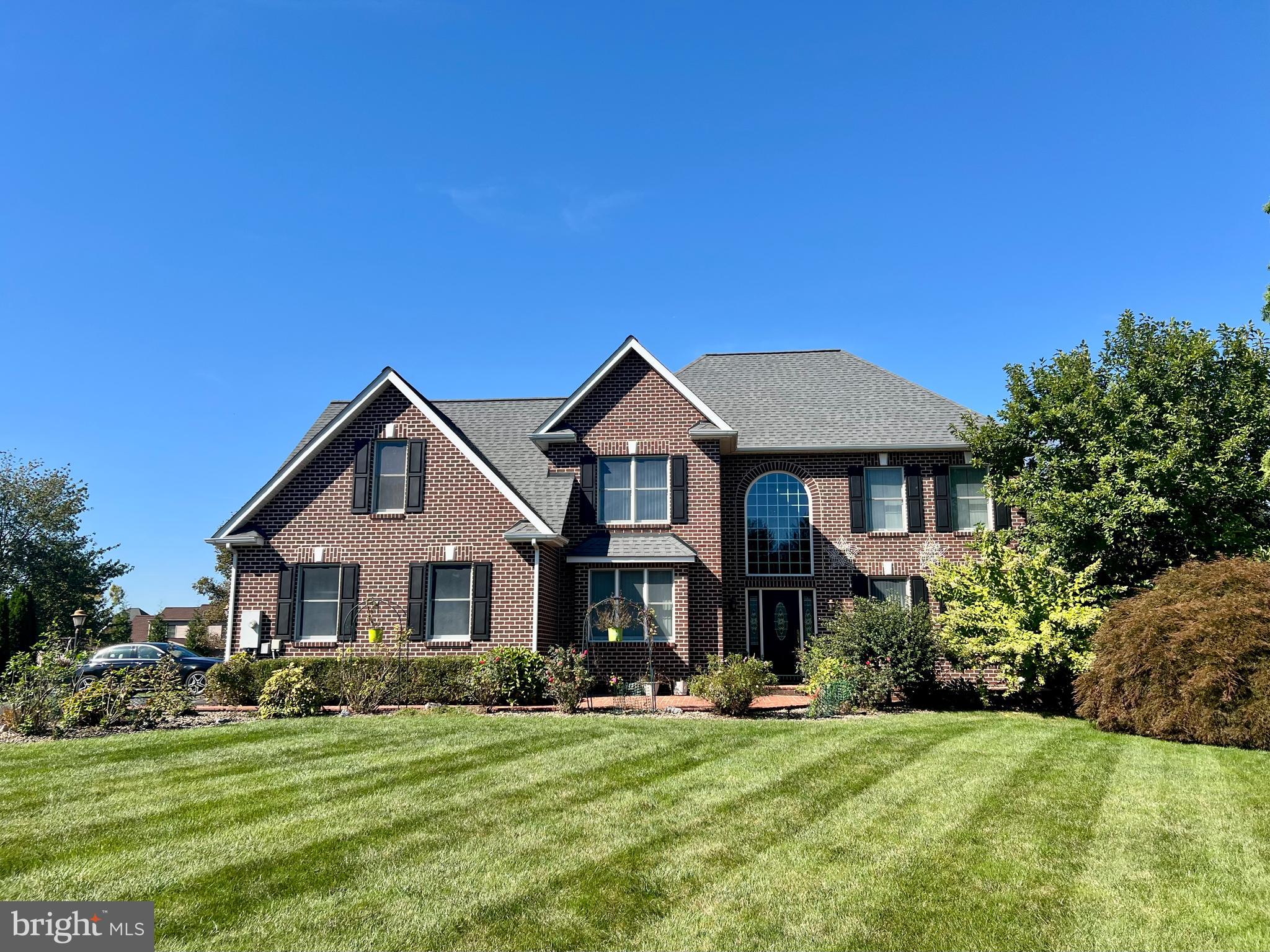 PREMIER LOCATION! EXCEPTIONAL QUALITY & BEAUTY INSIDE & OUT!   5000 + SF    This is picturesque, manicured, park-like setting, situated on a .52 ac lot in Scot Greene Estates.  Add, in a high-quality, all brick well maintained, three level expansive home with a floor plan that gives you endless possibilities. The home boasts over 5000 Sf with 4 defined bedrooms on the upper level, (2 being primary suites), 2 potential bedrooms (office & sunroom) on the main floor if needed and a potential additional room in the lower level that Owners have used as a bedroom in the past.  With a total of 5.5 baths, this home has many possibilities for you!  As you walk into an open two-story foyer you will find a well-defined living and dining rm.  French doors lead into a large office which could also double as an additional bedroom if needed on the main level.  The remodeled and updated kitchen expands into a two-story open family room with a second staircase, fireplace and doors leading to the wrap around porch. This area also leads to an exceptionally large sunroom with a full bath that could double as another primary bedroom for the main level. The entire sunroom is surrounded by the wrap around porch making this great for entertaining or enjoying your beautiful backyard from all views.  Laundry room is located on the upper level for convenience.  Lower level has two recreational areas, a full bath, a storage area plus a room Owners have used as an extra bedroom at times. The 2-car oversized garage has an EV outlet for charging your car if needed plus plenty of cabinets.  This home is full of extra storage areas. You do not want to miss your opportunity to tour this beautiful property.  This home has so much potential for a homeowner.  Move in and add your own special touches to this exceptional home!  Owners are offering a credit/allowance for changes Buyers may wish to consider due to the personalization in the home.  Schedule your showing now!