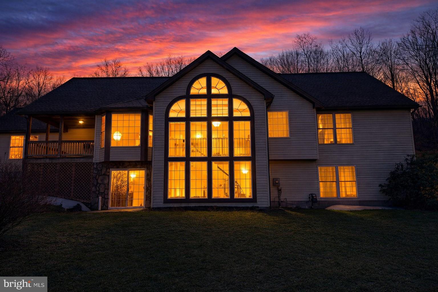 Beautiful contemporary two-story home set on a picturesque 2.5 acre wooded lot with a walk-out lower level. The stunning two-story wall of windows fills the home with natural light and creates a dramatic focal point in the main living area. Featuring multiple gables, an elevated deck, and expansive backyard space, this 3 bedroom, 3 bathroom home offers the perfect blend of architectural character and functionality. The walk-out basement provides additional living or entertaining potential, while the peaceful setting offers privacy and scenic views.Energy-efficient geothermal heating adds comfort and long-term savings. A rare opportunity to own a bright, spacious home in a serene setting with modern efficiency.