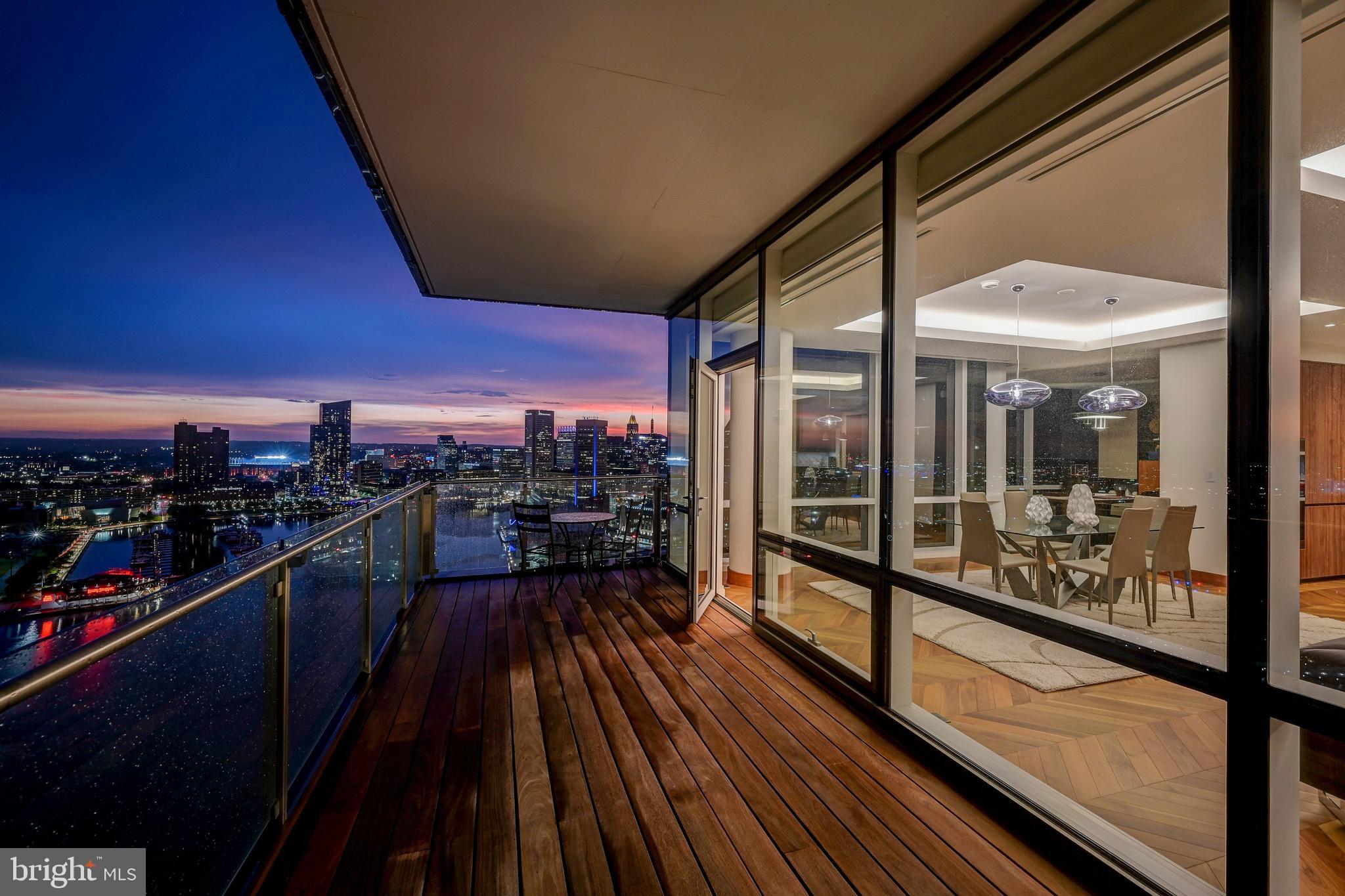 Live Amongst The Clouds in one of the BEST LUXURY VALUES IN BALTIMORE featuring an unobstructed view of Baltimore's Inner & Outer Harbor Glory. Highlighting the epitome of luxury condo living, residence 2501 features 2,200+ square feet oozing with high end finishes and seamless open floorplan. Newly refinished herringbone hardwood floors shine upon entering into the foyer and continue throughout the home. Making the turn towards the living area, floor to ceiling windows allow abundant natural light and the most stunning view of inner and outer harbor to shine through. The Miele appliances compliment a waterfall quartz countertop, two wine refrigerators, a separate ice maker, and double oven with state of the art broiler and heating tray. Find a perfectly sized home office or formal dining area off the side of the great room, which looks over the inner harbor and Baltimore's ever changing skyline. Custom lighting throughout the home accents the vibrant wood cabinets and lively paint selection.  Enter into the owners suite featuring the best views of the condo overlooking the inner harbor. The owners suite bathroom features a large rain shower with designer marble tile, a double vanity with extra counter space, and a comfortable soaking tub. The second full bathroom repeats the luxurious finishes with a rain shower as well as designer marble tiling. Bedroom number two has an equally beautiful view of downtown Baltimore's inner harbor. No expense was spared in the creation of this elegant masterpiece, from the custom window tinting treatments to the Crestron system making this residence controllable with the touch of a button. Tying all of this elegance together is the amenity floor on floor 28 of The Four Seasons Private Residences. A stunning endless pool featuring 180 degree views of Baltimore's harbor sits next to the full gym, oversized common areas ideal for entertaining, and a plethora of other amenities await. Don't miss the opportunity to own one of only 4 units with completely unobstructed views throughout the residence within the Four Seasons Private Residences Baltimore.