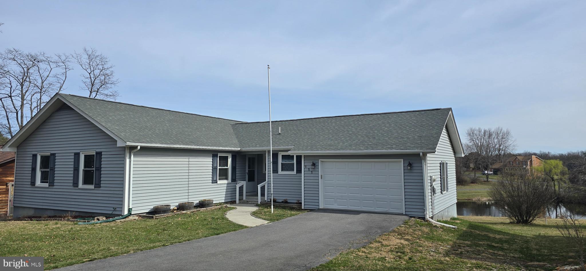 NEW ROOF 2020.   NEW WINDOWS 2023! ONE LEVEL LIVING! LAKE LIFE! It's the perfect time of year to make a move to Lake Holiday Estates, a gated community with 240 acre lake, kayaking, boating, water, skiing, clubhouse, sandy beaches, fishing, volleyball, tennis and pickleball!    
111 Masters Drive is conveniently located  close to the front gate and about a mile and a half from the clubhouse on the lake.  Enjoy one level living in this ranch style home with 3 bedrooms & 2 full baths.  The cozy family room has a wood burning fireplace to keep you toasty in the winter months!  Unfinished basement is perfect for an exercise room, game room, or storage. Large deck spans across the length of the home providing a beautiful view of the pond & the common area, peaceful settings with sunrises and sunsets and lots of nature