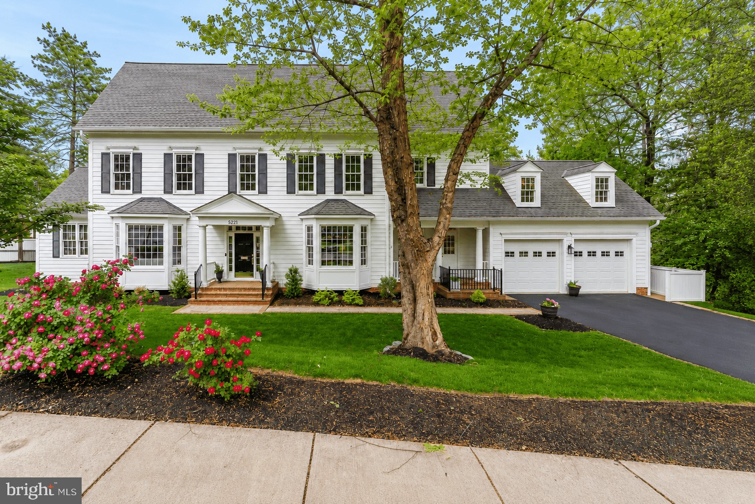 Welcome to this exceptional custom-built residence, thoughtfully designed by renowned architect Claude Lapp and constructed in 2007 by award-winning Welty Homes.

Perfectly positioned on a beautifully landscaped 0.3-acre corner lot in the heart of Bethesda, this sophisticated home offers timeless architecture, refined finishes, and an ideal floor plan for both everyday living and entertaining. A covered front porch, brick and flagstone walkway, French windows with wood mullions, and mature landscaping create striking curb appeal, while recent updates including fresh interior paint and new carpet throughout the upper and lower levels in 2026 provide a crisp, move-in ready feel.

Inside, hardwood flooring, recessed lighting, double crown molding, and French glass pocket doors enhance the elegant yet functional layout. The gourmet kitchen serves as the heart of the home, featuring abundant 42-inch white cabinetry, granite countertops, stainless steel appliances including a gas cooktop and double ovens, a center island with bar seating, and a breakfast area with built-in bench seating and plantation shutters. The kitchen opens seamlessly to the inviting family room with custom built-in bookcases, a gas fireplace with wooden mantel, and built-in surround sound system. Additional main level spaces include a sunroom with vaulted ceilings and access to the private rear deck, a formal living room with bay window, and a gracious dining room showcasing chair rail molding, bay window, and historic built-in china cabinets salvaged from the original 1919 home once located on the property. A versatile main level office or optional bedroom features original built-ins, plantation shutters, and direct access to a full bathroom. The thoughtfully designed mudroom includes a separate entrance, sink, cubby storage, cabinetry, and refrigerator rough-in with water line, while an attached two-car garage and three coat closets add convenience. A pre-wired elevator shaft servicing all three floors provides the easy capability to add an elevator in the future.

Upstairs, the spacious primary suite offers two walk-in closets and a luxurious bath with dual vanities, oversized shower, Jacuzzi tub, and private water closet. Three additional bedrooms include one with an en-suite bathroom and walk-in closet, while two others share a Jack-and-Jill bathroom with dual sink vanity. A well-equipped laundry room with cabinetry, folding counter, and hanging space is also located on the upper level. An expansive unfinished bonus room above the garage is insulated, pre-wired, and ready to become a home gym, office, or playroom.

The finished lower level provides impressive additional living space with high ceilings, a large recreation room with walkout access to the yard, a full bathroom, generous walk-in storage closets, and two oversized storage and utility rooms.

Ideally located approximately 1 block from National Institutes of Health, less than 1 mile from Walter Reed National Military Medical Center and Medical Center Metro Station, and moments from Downtown Bethesda, Wildwood Shopping Center, and the neighborhood Maplewood-Alta Vista Local Park, this exceptional home combines luxury craftsmanship, modern functionality, and an unbeatable Bethesda location!