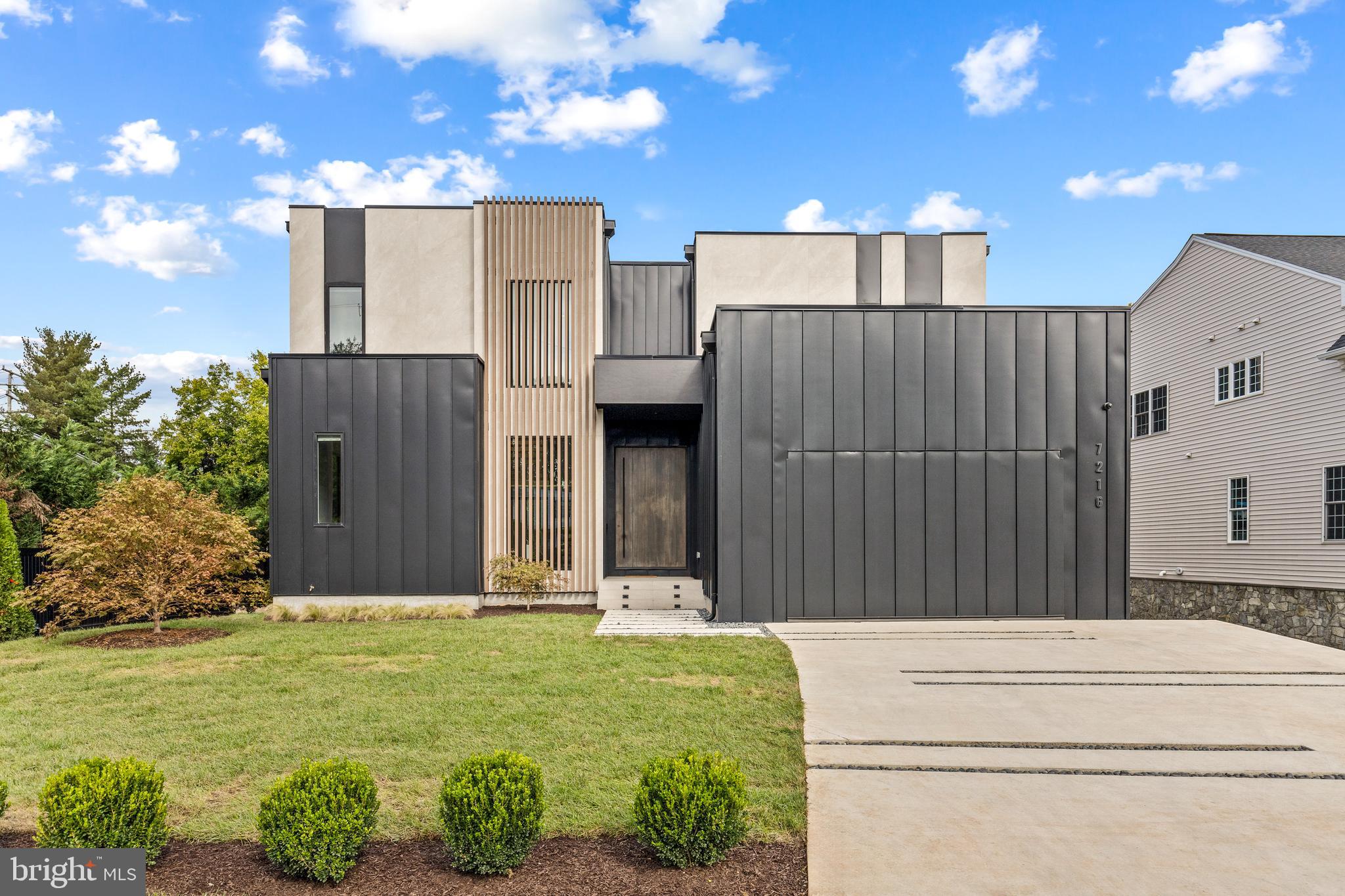 7216 Davis Court is a custom modern residence designed with a singular vision. Created for a private owner and realized by an accomplished architect, the 7,203-square-foot home explores proportion, light, privacy, and connection to the landscape with remarkable clarity.
The restrained street presence gives little away, gradually revealing expansive interiors with 12-foot ceilings and walls of glass that frame the outdoor living spaces. At the center of the home, two 10-foot sliding glass walls open directly to the pool terrace and outdoor kitchen, allowing the main living spaces to extend naturally outdoors. The swimming pool becomes the visual anchor of the home, reflected throughout the living spaces and bringing movement and light deep into the interior.
Six generously proportioned bedrooms, each with a private en-suite bath, provide exceptional comfort for family and guests. The home includes six full bathrooms, one powder room, 10-foot ceilings throughout the upper level, and 9-foot ceilings on the lower level, creating a consistent sense of volume across all three floors.
Amenities include a dedicated fitness room, private home theater, outdoor kitchen, and multiple spaces designed for gathering or quiet retreat. A restrained palette of warm contemporary materials is complemented by premium fixtures, carefully selected finishes, and confident moments of color that give the architecture warmth and individuality.
Homes of this quality and level of customization rarely become available. 7216 Davis Court offers an uncommon opportunity to own a modern residence designed with intention, executed without compromise, and built to stand apart for years to come.