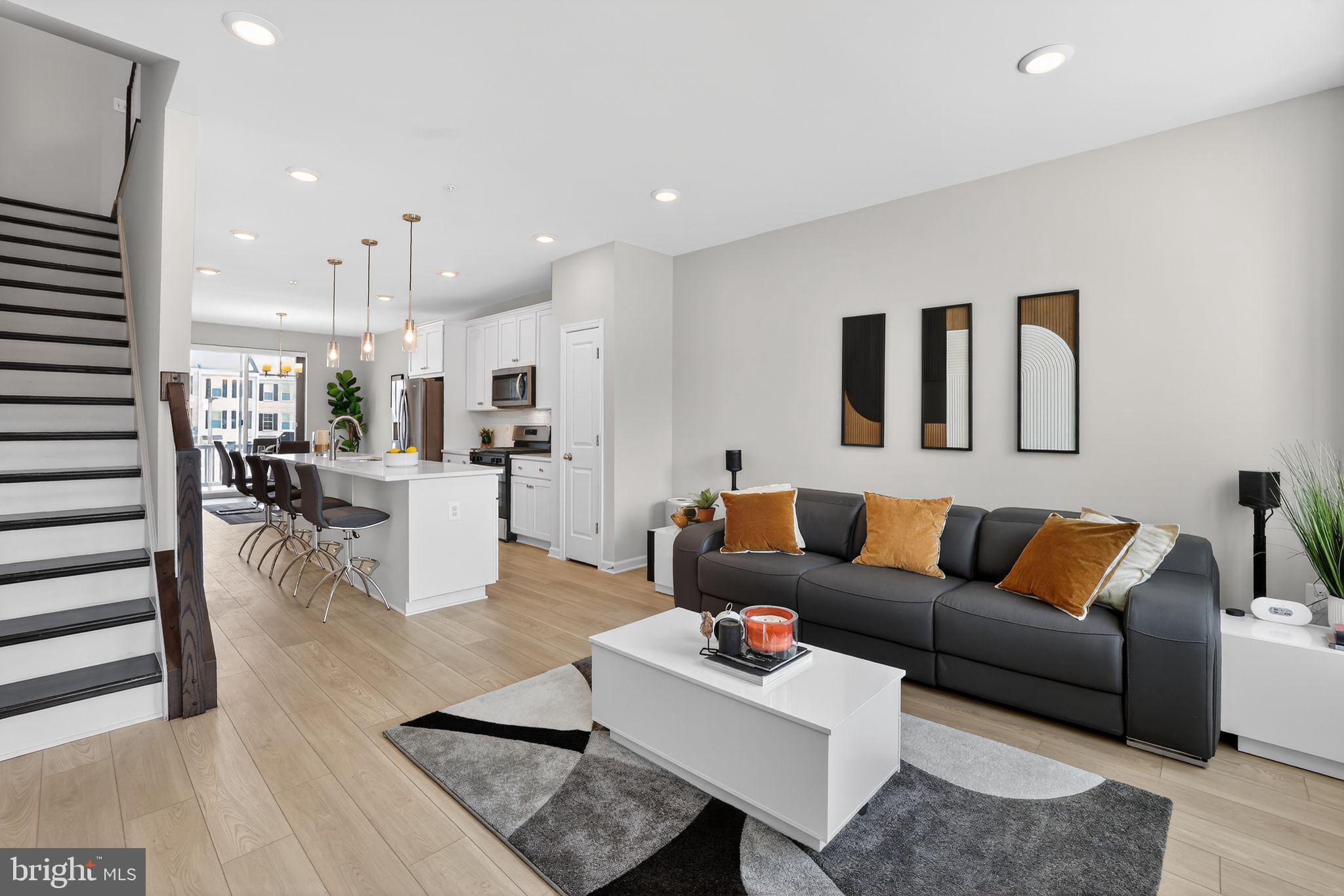 ***NOW OFFERING: $2,500 closing cost credit to Buyer on top of the $25,000+ in upgrades!!** Welcome to a nearly new, impeccably upgraded residence that delivers the sophistication of modern living with the warmth of a truly inviting home.

Less than a year old and already enhanced beyond builder standards, this exceptional three-bedroom, three-and-a-half-bath home makes an unforgettable first impression. Sunlight pours across wide-plank light Oak LVP flooring that spans every level, while dramatic Dark Oak stairs create a striking architectural statement. The heart of the home's main living space is both refined and welcoming. The open-concept main living space was designed for both refined entertaining and effortless daily living, anchored by a chef-inspired kitchen featuring striking quartz countertops, and upgraded appliance package. Sleek and modern finishes that feel both timeless and luxurious. Smart-home technology enhances everyday convenience, while custom cordless honeycomb shades with blackout overlays on every floor create a private, serene retreat day or night. The primary suite is a true retreat, featuring dual closets and a spa-inspired bathroom adorned with stunning ice-white quartz, frameless glass walk-in shower. A luxurious sanctuary to begin and end each day. A secondary bedroom enjoys the privacy and convenience of its own full ensuite bathroom. The versatile lower level adds even more value with a full bath and bedroom that includes a full wall bed — ideal for a luxe home office or private guest suite.

Step outside onto low-maintenance Trex decking, an ideal extension of your living space for effortless indoor-outdoor moments. An electric-vehicle pre-wire with Tesla charger included to reflect a home built for the future while grounded in timeless style.

Rarely does a home combine new-construction freshness, completed premium upgrades, walkable convenience, and true move-in-ready ease so seamless.