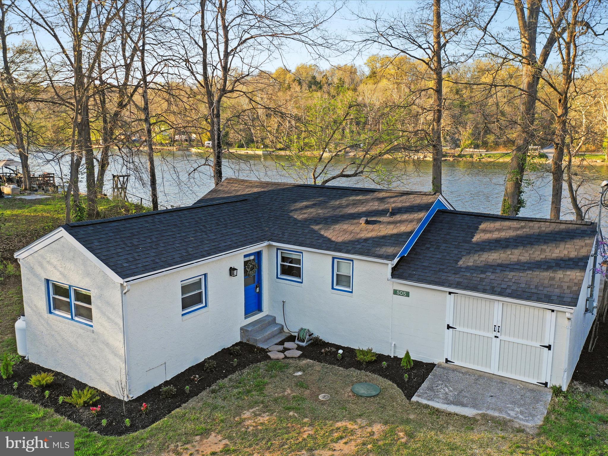Located along a rare deepwater stretch of the Shenandoah River, this 3-bedroom, 1-bath home offers a quiet escape. Set high above the waterline, it provides uninterrupted views of the river winding below, with direct access to all the fun it offers. With depths exceeding 15 feet, this section of the river is ideal for all water activities — from powerboating and jet skiing to kayaking, paddleboarding, swimming, and fishing. The property includes its own private floating dock, perfect for launching your next adventure or simply lounging by the water. A community boat ramp, just half a mile away, adds even more convenience for boaters. Plus, the adjacent lot is owned by the community, offering added privacy. Inside, large windows flood the space with natural light and offer peaceful river views. Step outside to the spacious patio and deck — perfect for sipping coffee as the fog lifts, gathering with friends under the stars, or unwinding by the fire as the river flows by. Recent updates include a brand-new roof and septic system, attic insulation, vapor barrier in the crawl space, fresh exterior paint, updated landscaping, and new flooring in the main bedroom. Just minutes from downtown Front Royal, local wineries, Skyline Drive, Skyline Caverns, and a variety of restaurants and year-round events on Main Street, this property offers the perfect balance. Let the river welcome you home!