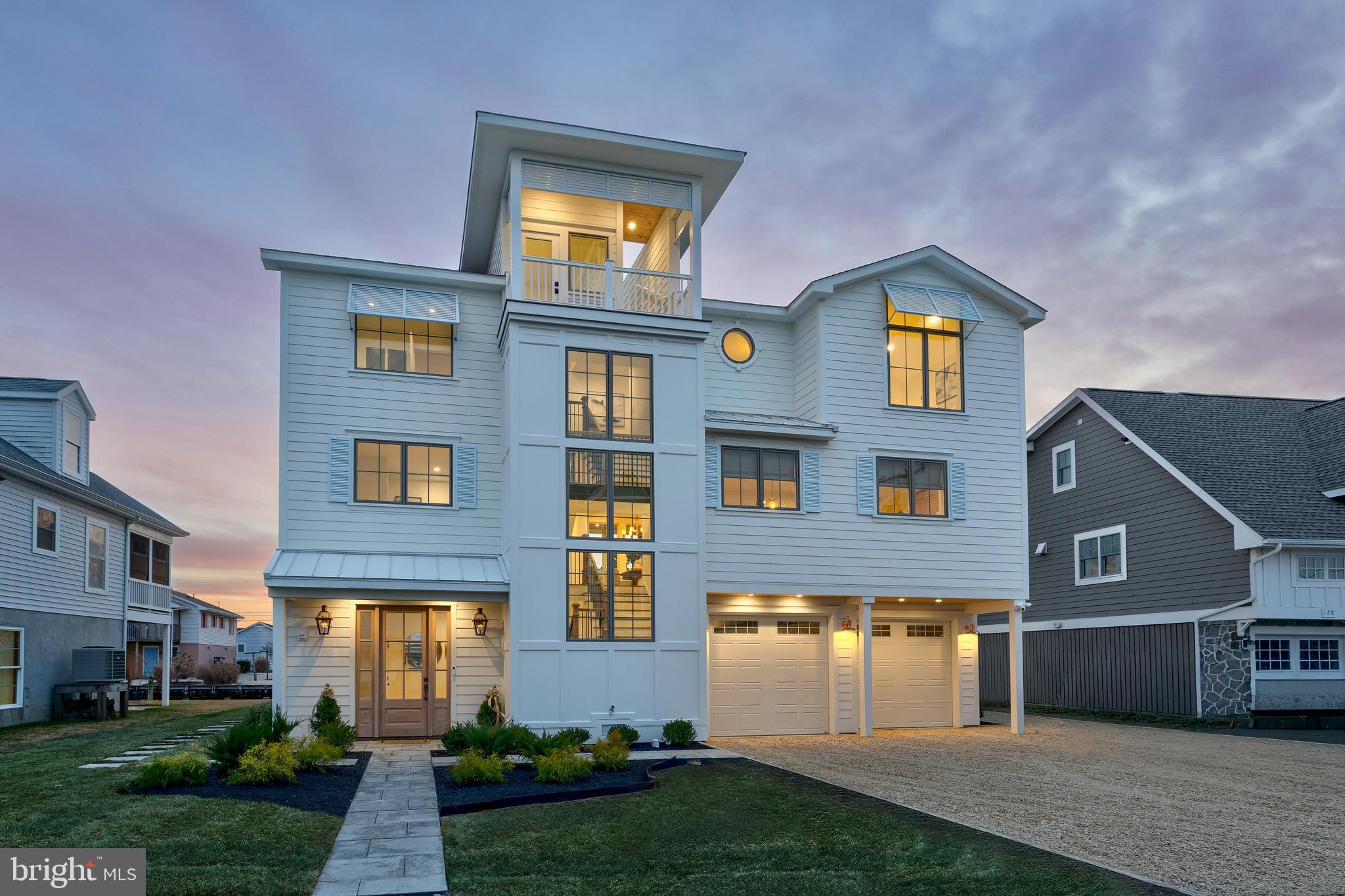 Merriam Webster defines the opportunity of a lifetime to be “of a chance or experience, such that it does not occur more than once in a person's life.” and one might argue that this residence is truly a once in a lifetime opportunity. 124 Layton is positioned mid block on a controlled cross-walk street which is a quick, and safe,  jaunt to the serene beaches of South Bethany. Whether you are looking for the ocean sounds, the maritime enjoyment of jet ski’s, boats, and kayaks with canal access just steps from your back dock, watching those boombastic 4th of July fireworks from your rooftop deck with Ocean View - or just soaking up rays from the tanning ledge in your private heated saltwater pool – this residence is truly a once in a lifetime coastal retreat for you and your chosen family.

Upon entry, you’re welcomed by a dramatic 15-foot foyer and a gracious oversized staircase leading to the main living level. This ground level maintains a large conditioned space, several storage areas and access to the two car garage. The main level is nothing short of showstopping. The open-concept living, dining, and kitchen space is truly breathtaking.  With a kitchen outfitted in only the finest of finishes like paneled Thermador appliances, 36” gas range, dual temp wine fridge, custom range vent hood, pantry and large island with ogee edge quartz surfaces – even I would want to learn to cook! The kitchen seamlessly flows into the living space with a gas fireplace, floor to ceiling windows and french doors opening to the pool and deck space. Just off the living and kitchen is the graciously sized dining area. The opposite side of the home maintains the primary suite on this level with two closets, an ensuite with limestone floor and shower surround, and soaking tub with access to the pool. This level also has a half bath with designer wallpaper and a convenient door with direct access to the pool so those wet footsteps aren't traipsing through the entire home. The third level continues to impress with a warm and inviting den space featuring custom seagrass wallpaper- perfect for an additional living space. There is a primary suite just off this space with vaulted ceiling and access to a balcony overlooking the pool and canal. On the other side of the home there is a third primary with vaulted ceilings and ensuite– yup, three primary bedrooms with ensuites, so no more fighting! This level also maintains two additional bedrooms with access to a balcony and sharing a hall bath with designer tile. A laundry room with custom cabinetry and quartz surfaces round this level off as you head up to the roof deck. With a view of the sunsets, canal, and ocean – this roof is polished off with water, electric and gas hookup. The home has several thoughtful designer touches such as gas lanterns that adorn either side of the custom stained mahogany entry door, designer wallpaper throughout, color matched exterior paint and coordinating garage doors, exterior storage, two private outdoor showers, landscaping with hardscaped patio and brand new bulkhead and dock on a lot and a half. This isn’t just a home. It’s a rare coastal masterpiece—and an opportunity that truly may only come once.