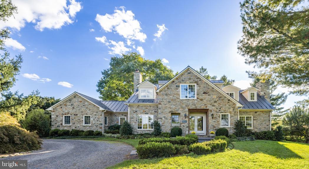 Stunning!!! Harborvale is a beautiful 51-acre estate, 5 minutes from historic Middleburg. The gated entry opens into a long, straight drive through an allee of vibrant trees, which leads to the stunning home. The drive then continues to the 3-car garage, the 5-stall stable and the 3-bedroom tenant house.  Beautifully sited, the land surrounding the home is gently rolling and mostly open with gorgeous gardens, pastureland, fenced paddocks, and a spring-fed pond. Three automatic generators service this property’s home, tenant house and stable.
Built in 2017 by the current owners, the previous home was taken down to the foundation leaving only the stone fireplace in the family room. The mortar from the previous exterior’s stones was removed and the stones were used to build the current home. The original hearth stone is now the step at the entrance.
Heavy oak doors open into a covered entry of the home providing comfort for one’s guests. Upon entering the foyer, one realizes that this home was built to showcase the tremendous light and views. To the right is an exquisite private suite with anteroom, which opens to the library with a wood burning fireplace and a full bath. To the left of the foyer is the elegant formal living room also with a wood burning fireplace. Returning to the foyer, the gleaming floors lead straight through the bar area into the light filled sunroom. The bar area features natural cherry cabinetry, access to the elevator, and a door leading to the basement.  In the sunroom, one realizes how ideal this home is for elegant, as well as casual entertaining. Four sets of French doors provide tremendous light and open out to the terrace and stunning gardens of perennials, flowering and fruit trees. The sunroom is also adjacent to the grand dining room. At one end of the dining room, handsome, built-in cabinetry flank the French doors which open into the formal living room. At the other end of the dining room is a large walk-in bay window, which brings in the natural light. Beyond the dining room one enters the spacious family room/kitchen and breakfast room. 
The family room features the original stone fireplace and a vaulted ceiling. It is completely open to the large breakfast area and the kitchen. Beyond the kitchen is the laundry room, mud room and a powder room.
Returning to the foyer, wide steps lead to the upper-level hallway. The hallway provides access to the primary suite, 3 additional bedrooms, a hall bath, and a laundry closet which houses a stacking washer and dryer.  The exquisite primary suite offers tremendous privacy, and features an elevator, breakfast bar, sleeping room, sitting room with gas fireplace and balcony, and 2 full baths. The second bedroom features a private bath and a balcony. The 2 additional bedrooms are very charming and share a hall bath.  
Located in prime Orange County Hunt Territory, this estate has hosted Hunt Meets. The horse facilities include a new stable with 5 stalls, a washroom, tack & feed room and a hayloft. In addition to the stable there is a riding ring, 2 – 5 acre fenced fields with run-in shed, one small field, one round pen and a mowed bridle path around the property. 
The 51-acre estate of Harborvale is within 5 minutes of the historic town of Middleburg on a very quiet lane with only 6 other estates. The land is currently in Open Space Land Use through 2027 and is mostly surrounded by estates protected by Conservation Easements. This is a tremendous location, convenient to town and very private.