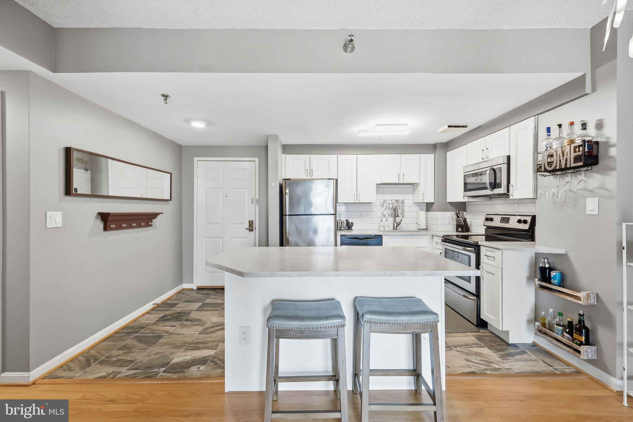 Right in the heart of Rockville, Unit #306 at The Victoria is a beautifully renovated 1 BR + den, 1 BA condo. The kitchen was fully renovated in 2016 — opened up and connected to the main living area, with white shaker cabinets, quartz countertops, a center island with bar seating, subway tile backsplash, and stainless steel appliances — all flowing into a light-filled space with hardwood floors and a glass-enclosed solarium that can be enjoyed year-round. The bathroom was updated in 2022 with ceramic tile, a frameless glass shower with rain shower head, and a mosaic hex tile floor. The den — with built-in shelving and French doors — works perfectly as a home office or guest room, while the primary bedroom offers a generous walk-in closet. In-unit washer/dryer and one assigned underground parking space (Spot #60, G2).

Building amenities include a recently renovated lobby, fitness center, and outdoor courtyard terrace, with on-site professional management and gas, water, and HVAC maintenance all covered by the condo fee. The association is exceptionally well-funded — over $3.5 million in reserves — with no special assessments.

Steps from the Rockville Metro (Red Line) and MARC train, with Trader Joe's, bars and restaurants, the Regional Library, Regal Cinemas, and year-round Town Center events all within walking distance.