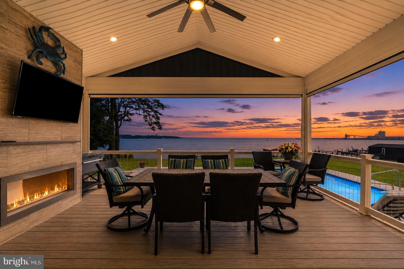 Imagine ending each day with the sun setting over the water, your boat just steps away, while gathered on a covered porch where every detail was designed for effortless living. This custom waterfront estate isn't simply a home, it's the backdrop for a lifetime of unforgettable moments. Built with intention and positioned on 1.26 elevated and beautifully landscaped acres secured by a private electronic gate, this one of a kind home offers a true coastal lifestyle. Expansive windows, soaring 10-foot ceilings, and an open floor plan capture breathtaking water views throughout. At the heart of the home, the chef's kitchen features a gourmet island with breakfast bar, premium appliances including Breville convection microwave grill combo, KitchenAid microwave/oven, oversized refrigerator, double ovens, lighted cabinetry, and a walk-in pantry. Through double sliding doors you’ll discover a covered composite deck complete with vaulted ceilings, a fan for a never ending breeze, retractable screens, propane fireplace, television, and grilling station where you’ll enjoy sweeping views of the waterfront. Sip your coffee while you watch the eagles, osprey and great blue herons soar by. This is truly where you’ll enjoy seamless indoor/outdoor living. Outside, your private resort awaits. Relax beside the 18' x 36' inground pool with custom Eagle Ray mosaics, built in benches and diving board, or head to the 120-foot private pier with picnic area,10,000 lb boat lift, and dual jet ski lifts for an evening on the Chesapeake. Designed for entertaining and everyday comfort, this spectacular home offers 5-6 bedrooms, 4.5 baths, a private office, loft/library, elevator servicing every level, and a finished lower level ideal for guests, recreation room or multi-generational living. The waterfront primary suite provides panoramic views, dual walk-in closets, and a spa-inspired bath with a soaking tub overlooking the shoreline. Exceptional craftsmanship includes 2x6 construction, 2-inch closed-cell spray foam insulation, dual-zone HVAC, central vacuum, an oversized climate-controlled garage capable of parking full size SUV or trucks. A sturdy 10x16 shed provides additional outdoor storage. At more than 20 ft above sea level, no flood insurance is required. Enjoy your bay front lifestyle without the worry. Built in 2021, offering timeless quality, unmatched waterfront amenities, and future subdivision potential, this is a rare opportunity to own a home where every detail was thoughtfully designed, and every day feels like a vacation. Located on a quiet street in a well-established neighborhood that is rich with local history, near 1300 acre North Point State Park and Fort Howard Park, you’ll feel worlds away while staying close to Baltimore, Annapolis, and DC. Boaters will appreciate easy access to top destinations on the Bay. Some homes are simply built. Others are thoughtfully crafted to become the place where life's best memories unfold. This is one of them. Schedule your private tour and experience what makes this extraordinary property unlike anything else on the market.