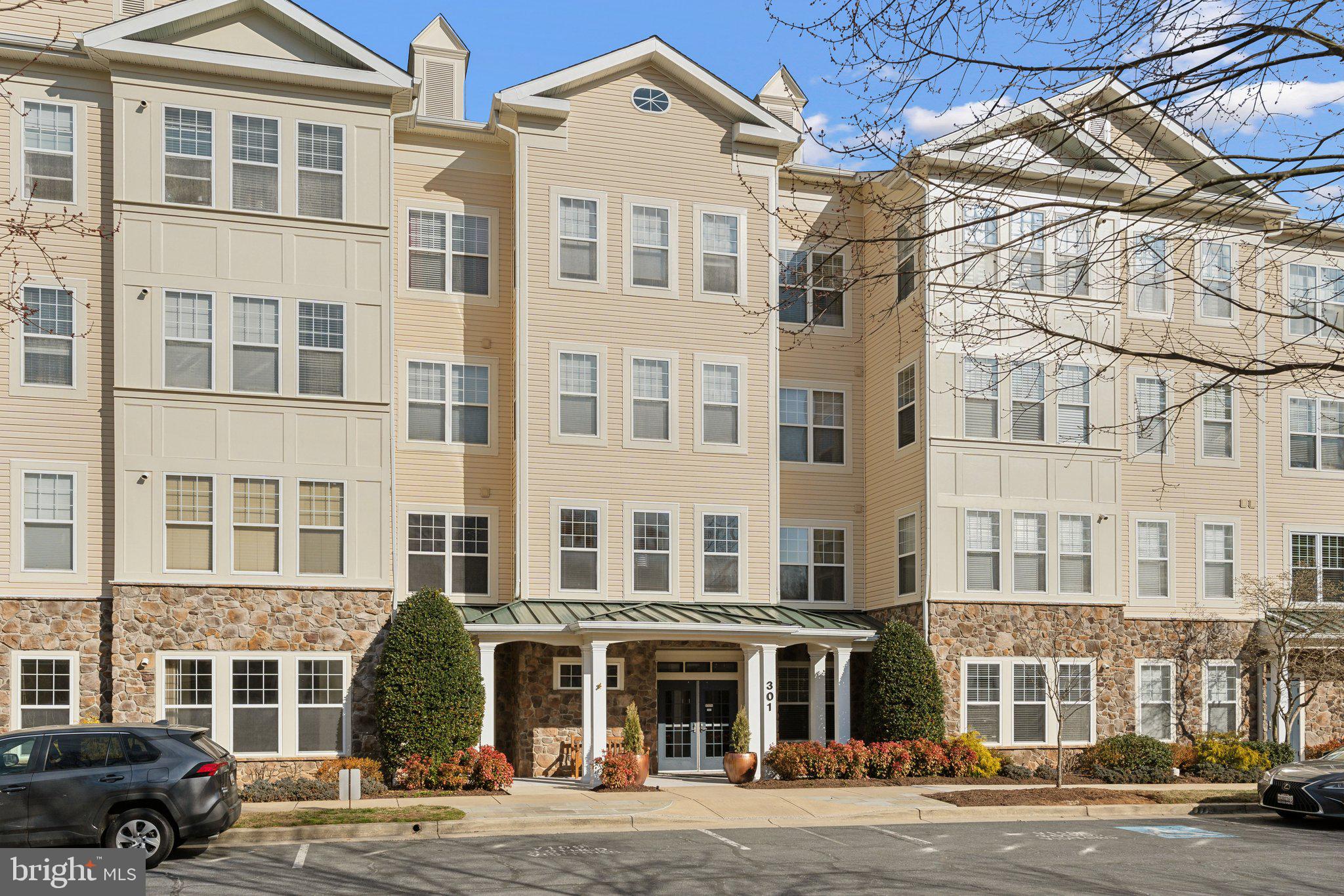 **OPEN HOUSE CANCELLED- HOME UNDER CONTRACT***

Spacious and light-filled, this 2-bedroom, 2-bath condo offers an exceptional floor plan, garage parking, and a private storage unit. The large living and dining areas seamlessly flow into a sunroom flooded with natural light—perfect for a home office, reading nook, or relaxation space.

The fully updated kitchen features gleaming quartz countertops, stylish white cabinetry, luxury vinyl plank flooring, and decorator lighting. A brand-new refrigerator and newer dishwasher complete the modern look.

Retreat to the luxurious primary suite, featuring brand-new carpeting, a walk-in closet plus a second closet, and a stunning ensuite bath with a brand-new decorator-tiled walk-in shower, double-sink vanity, and elegant lighting. The spacious second bedroom also boasts large windows, new carpeting, and a generous closet. The second full bath has been tastefully updated with a new vanity, mirror, and decorator lighting.

The unit also includes a dedicated laundry room with a washer and dryer, additional shelving, and a storage closet for extra convenience.

Located in a secure elevator building with a welcoming lobby, this condo offers unbeatable convenience. Enjoy easy access to the community pool, clubhouse, and fitness center, plus all the shopping, dining, and entertainment the Kentlands has to offer—just seconds away!