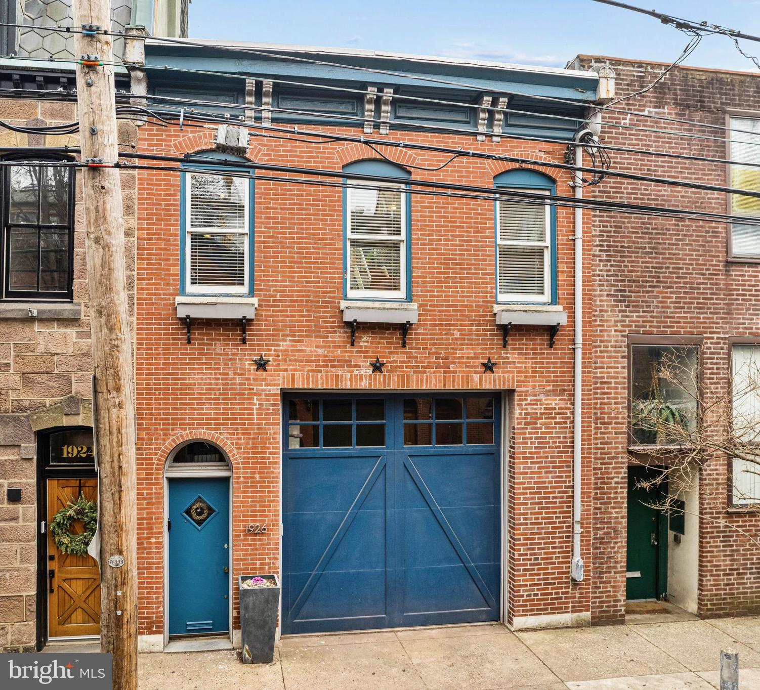 Spacious and bright contemporary carriage house in prime historic Spring Garden location. Garage and entrance on the 1900 block of Brandywine. Entry foyer with exposed brick wall, tile floors, two large coat closets and direct access door to garage. The entire house is illuminated by a central, large atrium glass roof. Open floor plan living room, dining room and kitchen with South-facing windows and door. Wood floors, 11ft ceilings, gas fireplace, custom millwork built-ins and contemporary cook's kitchen with a large island create a wonderful space for entertaining. Also on the ground level is a bedroom or office and full tiled bath with a large shower. Dramatic glass and chrome accented stairway leads to the open and sunny second floor. This level with wood floors and multi-level ceilings has a spacious bedroom with multiple closets, large bathroom with double sink vanity and sliding glass door and tile shower and a separate laundry room. The remaining space on the second floor is open plan den, workspace with built-in desk, shelving and closets. This home was custom built or two empty-nesters with dramatic space available. The precedent has been set on Brandywine Street for adding a third floor. Rooms could be added to the second floor or on the roof without sacrificing the atrium or the South-facing IPE Wood deck  with skyline views, gas-line grill and planters. This is a gracious contemporary space with a garage, a rooftop deck in a terrific quiet location, close to the parks, MLK and Kelly Drives, museums, universities, restaurants and public transportation.