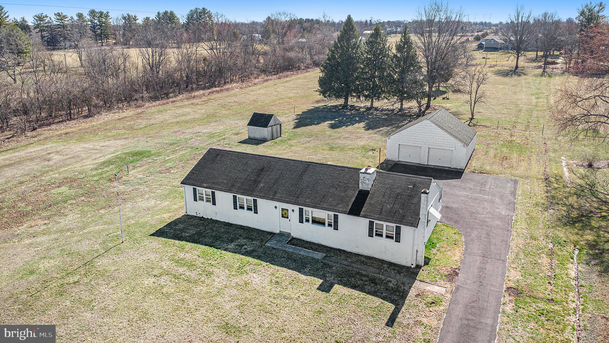 Don't miss this rare opportunity to own  a ranch home on over 3 ACRES in the desirable Towamencin township within the North Penn District!  Conveniently located, with easy access to  Skippack Village, Fischer's Park and the turnpike.  As you step inside, you are welcomed by a cozy family room with a wood-burning fireplace taking center stage framed by custom built-in bookshelves waiting for your personal touches.  Adjacent to the family room is the dining area, perfectly situated next to the kitchen creating a natural flow  between both gathering spaces.  The kitchen overlooks the  expansive rear yard and opens to a large family bonus room.   The additional family bonus room features a wood-burning stove, perfect for keeping warm on those chilly nights.  From the bonus room step into the sunporch which provides easy access to the backyard and detached 2-car garage. The sunporch is a great space to start the outdoor activities-let the fun begin!   This room allows easy access to the rear yard and the free-standing two-car garage.  There are three nice sized bedrooms and one full bathroom on the left side of the house.  All the rooms have lots of natural light and hardwood floors.  The basement, though unfinished, offers endless potential for storage, a workshop, or a craft room.  If you've been dreaming of owning land with room to grow, this is your chance. The property extends well beyond the garage, providing ample space for outdoor activities, gardening or simply enjoying the serene surroundings. Schedule your appointment today and explore the possibilities this property has to offer.  Offers due Monday, 3/23, by 3pm!