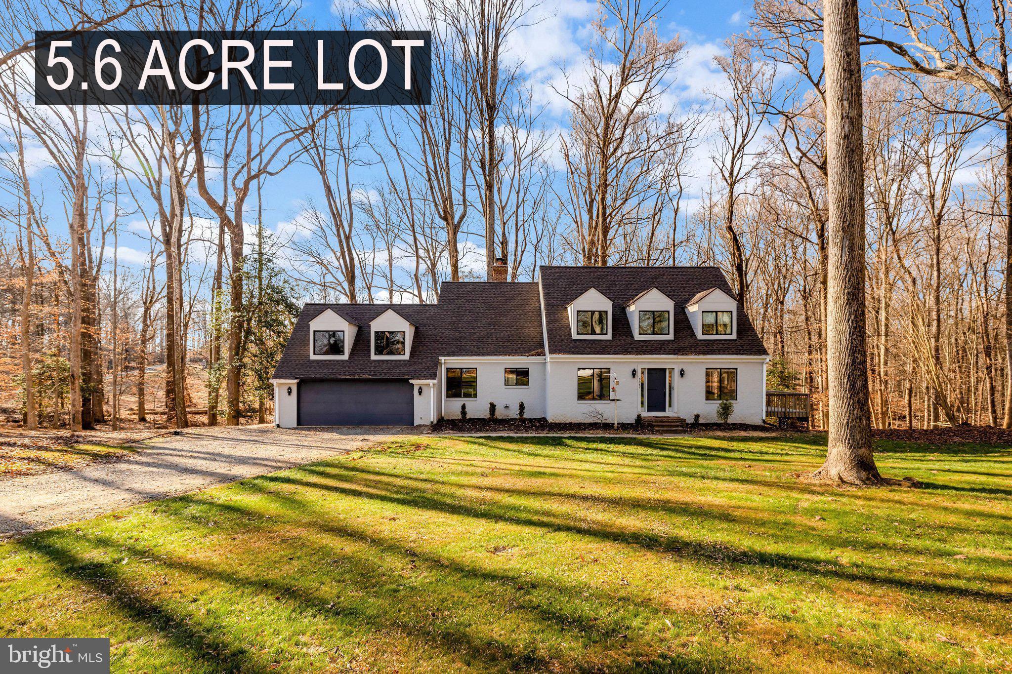 Set on 5.6 private acres in Great Falls, this beautifully renovated 4-bedroom, 3-bath home combines refined interiors with peaceful surroundings. Hardwood floors run throughout, enhancing the home’s bright, open feel. The main level features a light-filled living room with deck access, a chef’s kitchen with Viking range, wall oven, granite countertops, and maple cabinetry, plus a dining room and inviting family room with wood-burning fireplace. A stunning sunroom with walls of windows and skylights opens to the wraparound deck. A main-level bedroom/office, full bath, and spacious mudroom/laundry complete this floor. Upstairs, the owner’s suite offers multiple closets and a renovated bath with travertine floors, double vanity, and frameless glass shower. Two additional bedrooms, a loft, bonus room, and full bath provide flexible living space. The walk-out lower level is framed for future rooms with a bath rough-in and abundant natural light—ready for your customization. A rare opportunity for privacy, space, and modern updates in an exceptional Great Falls setting.