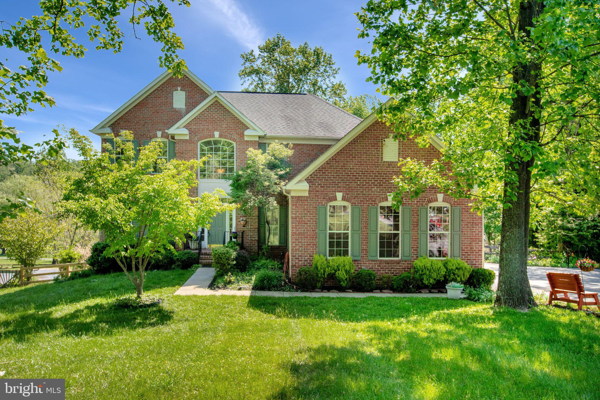 Set along one of the area’s most scenic stretches, this stately brick estate offers a rare balance of privacy, sophistication, and natural beauty on just under two private acres. Surrounded by mature trees and seasonal blooms, the property feels like a true retreat — secluded and serene, yet close to beloved local destinations. Less than a mile up Falls Road, Misty Valley Farms produce and flower market, John Brown Coffee, and John Brown General Store & Butchery add charm and convenience to everyday life. At home, the grounds are equally compelling: an exceptional backyard sanctuary centered around an in-ground pool with a brand-new liner and new mechanicals, framed by wooded views, generous entertaining space, and infrastructure in place for a future heated pool system. Immediately beyond the rear fence, direct access to Oregon Ridge Nature Center offers trails, a small lake, pavilions, and protected flora and fauna as a remarkable extension of your own personal landscape. A freshly sealed, tree-lined driveway creates a graceful approach, and the home reveals itself with timeless presence and understated grandeur. Inside, a light-filled two-story foyer opens to expansive interiors defined by light, scale, and refinement. In the formal living and dining rooms, striking floor-to-ceiling windows and elegant bay windows draw sunlight deep into the home, bathing the spaces in natural light throughout the day and creating an airy, luminous atmosphere that feels both grand and inviting. Richly stained hardwood floors and new luxury vinyl plank flooring add warmth and sophistication across the main level. At the heart of the home, you are greeted with a stunning panoramic view. The upgraded kitchen opens seamlessly into the rear sunroom, one of the residence’s most captivating spaces. Wrapped in windows and accented with skylights, the sunroom is filled with natural light from morning to evening and offers uninterrupted views of the private backyard and pool. With direct access to the rear deck, it creates an effortless connection between indoor and outdoor living, ideal for both quiet daily moments and elegant entertaining. Just beyond the kitchen, the family room offers a warm and inviting gathering space with a propane fireplace, while a spacious laundry room adds convenience. The impeccably updated three-car garage, with finished drywall interiors and newly refinished floors, extends the home’s thoughtful functionality and offers exceptional flexibility for storage, a workshop, fitness area, or hobby space. Upstairs, the primary suite is introduced through French doors and serves as a private retreat, complete with a generous walk-in closet and a spa-inspired bath with soaking tub. Three additional bedrooms are beautifully proportioned, and the hall bath offers both comfort and style. The bright walkout lower level adds even more versatility with a substantial bedroom featuring three closets, a convenient full bath, and expansive recreation and living space ideal for guests, entertaining, hobbies, extended stays, or multi-generational living. What makes this home so compelling is not simply the caliber of its features, but the lifestyle it affords — bright, private, and deeply connected to the beauty of its surroundings. Just minutes from Hunt Valley, Towson, shopping, dining, commuter routes, and outdoor recreation, and zoned to highly desired Mays Chapel Elementary and Dulaney High School, it is a rare opportunity to enjoy refined living in an extraordinary natural setting.