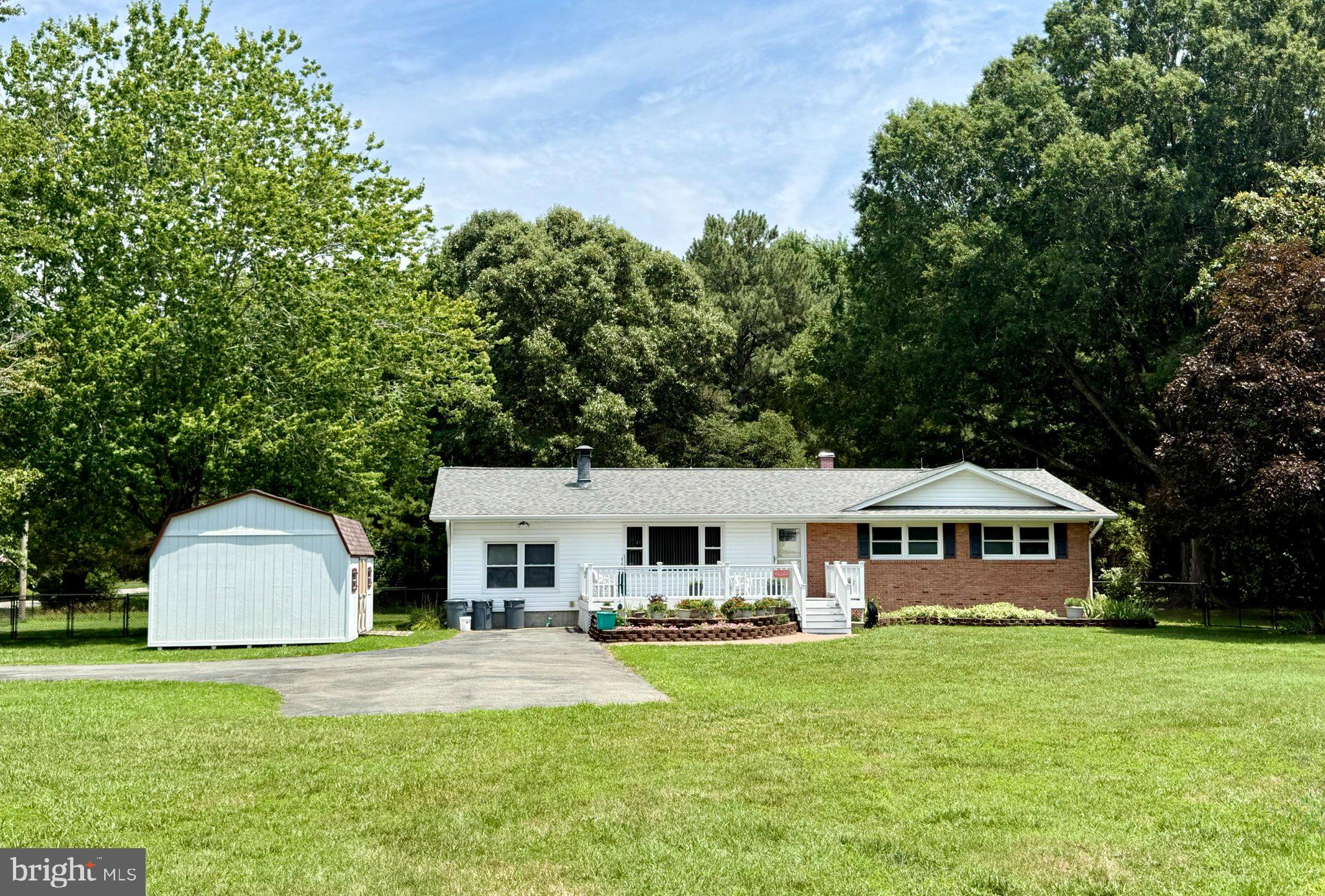 Located in the highly sought-after Society Hill community, this home offers close proximity to the water with a partial view of Breton Bay. Just one street from the members-only beach access, you'll enjoy exclusive community amenities including a picnic pavilion, fishing pier, and playground—perfect for embracing the waterfront lifestyle.

The home was extensively remodeled in 2008 with quality upgrades that include new siding, double-hung windows, gutters with leaf guards, and a beautifully updated kitchen. The kitchen features custom wood cabinetry by Miller Cabinet Makers, granite countertops with a breakfast bar, making it ideal for both everyday living and entertaining. The roof was replaced in 2020 for added peace of mind.

Inside, you'll find  wood floors throughout much of the home, a warm and inviting family room highlighted by a brick fireplace with a gas insert, and custom built-in bookshelves in both the family room and dining area that coordinate perfectly with the kitchen cabinetry. A private office provides the perfect space for working from home or managing household tasks.

The partially finished basement offers exceptional versatility with a game room, craft room, workshop, and laundry area, providing plenty of space for hobbies, recreation, and storage.

With its thoughtful updates, spacious living areas, desirable community amenities, and convenient location just one street from the beach, this home offers an exceptional opportunity to enjoy life on Breton Bay.