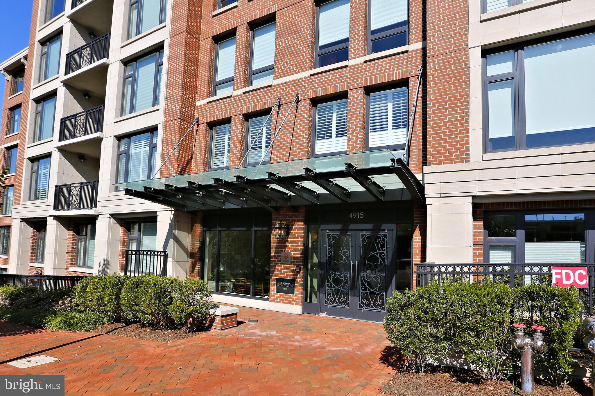 Don't miss this special opportunity! SELLER WILL PAY 3 MONTHS OF CONDO FEES! Gorgeous, sun-filled home at Hampden Row in downtown Bethesda! NO NEED TO USE AN ELEVATOR- THIS UNIT IS ON THE LOBBY LEVEL. This unit features 2 bedrooms, 2 full bathrooms and over 1,100 square feet of living space. As you enter, you will fall in love with the generous gourmet kitchen, equipped with quartz countertops, ample white cabinetry, and top-of-the-line stainless steel appliances. The large center island provides seating for four and opens up to the spacious family room. Other details include a separate breakfast area and built-in reading nook with a storage bench below. The huge, oversized windows flood the space with light, but are also fitted with automatic Hunter Douglas shades for the times you are seeking privacy.   Make your way down the hall to find a lovely primary suite with coffered ceilings, tons of light, and a huge walk-in closet. The primary full bathroom is outfitted with a large walk-in shower, designer lighting, and dual vanity with quartz countertops. The second bedroom is also sizeable and can be used as such or as a private home office. The second full bathroom also features quartz countertops, ceramic tile, and ample cabinet space. Other features include hardwood floors throughout, 10 ft. ceilings, full-size W/D, and 1-car garage parking space. Located just moments from metro and all that downtown Bethesda has to offer, including countless dining, shopping, and entertainment options -this home is the perfect 10!