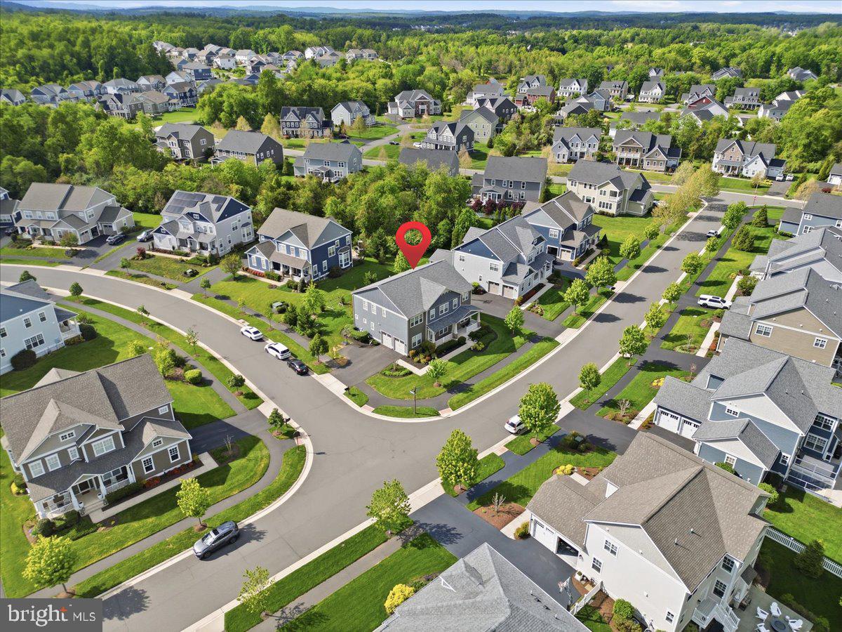 Luxury Living in Willowsford | 6 Bedrooms | 5.5 Bathrooms | Main-Level Suite | Finished Walk-Up Basement |

Welcome to 40777 Foxtail Fields Drive, a beautifully appointed luxury home in the highly sought-after Willowsford community in Aldie, Virginia. Built in 2018 and thoughtfully upgraded throughout, this exceptional residence offers over 5,200 square feet of refined living space designed for both everyday comfort and elegant entertaining.

With 6 spacious bedrooms, 5 full bathrooms, and 1 half bathroom, this home features a versatile floor plan ideal for modern living, multi-generational households, or extended guest stays.

The upper level offers 4 generously sized bedrooms, including a luxurious owner’s suite with a spa-inspired bathroom and expansive walk-in closets. One of the secondary bedrooms feature private en-suite bath, while the 2 additional bedrooms are connected by a well-designed Jack-and-Jill bathroom. The convenient upper-level laundry room adds everyday functionality.

On the main level, a private bedroom with a full bath provides the perfect setup for guests, in-laws, or a dedicated home office.

At the center of the home is a stunning gourmet kitchen featuring upgraded cabinetry, granite countertops, stainless steel appliances, a gas cooktop, wall oven and microwave combination, designer backsplash, and an oversized center island that flows seamlessly into the spacious family room. The dramatic floor-to-ceiling stone fireplace creates a warm and inviting focal point.

Beautiful hardwood flooring, elegant architectural details, abundant natural light, and tasteful finishes can be found throughout the home.

The fully finished walk-up basement offers exceptional flexibility with a large recreation area, custom wet bar, private bedroom and full bath, dedicated gym and fitness room, and separate washer and dryer hookups, making it ideal for an in-law suite, long-term guests, or additional entertaining space.

Additional highlights include:

• Extended driveway and side-load garage
• Premium corner lot
• Floor-to-ceiling stone fireplace
• Iron baluster staircase
• Hardwood flooring throughout main living areas
• Custom wet bar
• Walk-up basement
• Dedicated gym and fitness room
• Main-level bedroom with full bath

Located within one of Northern Virginia’s premier lifestyle communities, Willowsford offers resort-style amenities including pools, fitness centers, scenic walking trails, parks, community events, and its renowned farm-to-table lifestyle.

This is a rare opportunity to own a move-in-ready luxury home that combines space, functionality, and timeless design in one of Aldie’s most desirable communities. Schedule your private tour today.