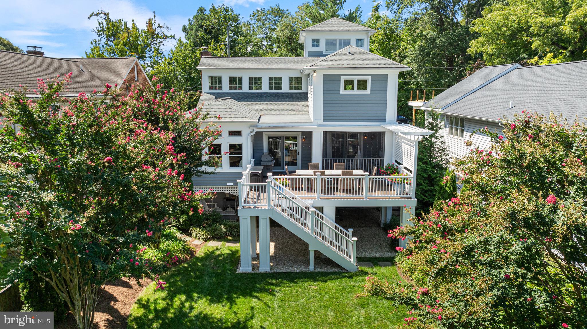 Every day feels like a vacation at this coastal retreat in the highly sought-after Bay Ridge community. Perfect for those seeking a peaceful, low-maintenance lifestyle or a serene second home by the water, this stunningly remodeled property, designed by Alt Breeding Architects, offers main level bedrooms with deceptively spacious living and breathtaking Chesapeake Bay views.

Multiple outdoor areas, from the screened porch to the lush backyard and front sitting areas, offer plenty of space to relax or entertain. Whether you’re unwinding on the deck, heading to the beach-side community pool,  or exploring the community marina and scenic walking trails, the coastal lifestyle is yours to embrace.

While charming from the outside, with its sunny yellow door and beautifully landscaped yard, the home reveals expansive, airy interiors that are sure to surprise and delight. Discover an open living area with cathedral ceilings, hardwood floors, and a wood-burning fireplace to relax by or entertain. The kitchen is a true gathering spot, featuring a stone island, walls of windows, and a dining area that leads to the newly added Timbertech deck—ideal for enjoying the coastal breeze. Great for entertaining.

The upper-level primary suite is a private retreat with panoramic Bay views, a luxurious spa-like ensuite, and a spacious dressing room. A spiral staircase leads to a versatile space, perfect for a yoga studio, home office, or private getaway. The sun-filled walkout lower level provides additional living space, plus space to easily convert back into a 4th bedroom, offering convenience and privacy for guests, as well as additional living area.

Located just minutes from downtown Annapolis, this Bay Ridge gem perfectly blends modern luxury with coastal charm, making it an ideal year-round residence or a tranquil escape.