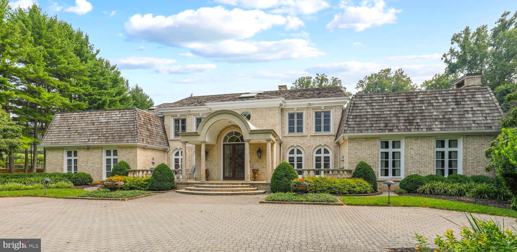 MAGNIFICENT TREE LINED BRICK DRIVE  LEADS YOU TO THIS CUSTOM BUILT EXTRAORDINARY HOME.  YOU WILL BE HONORED TO HOST YOUR FRIENDS AND FAMILY.  IMPRESSIVE ENTERING  THE  ELEGANT FOYER WITH OPEN WROUGHT IRON STAIRCASE.  SPECIAL FEATURES INCLUDE ARCHITECTURAL MOLDINGS; FRENCH DOORS AND WINDOWS THROUGHOUT, VAULTED & COFFERED CEILING; SOLID WOOD DOORS,  HARDWOOD , MARBLE FLOORING.
BEAUTIFUL FORMAL LIVING ROOM.  BANQUET SIZE DINING ROOM W/BUTLERS PANTRY CLOSE BY.  GOURMET KITCHEN W/GRANITE COUNTERTOPS, ISLAND , COUNTER SEATING; MORE THAN AMPLE CABINETS ADJOINING A FULL SIZE BREAKFAST ROOM W/SITTING AREA AND FIREPLACE.  KITCHEN PASS THROUGH TO SUN LIT MULTI USE ROOM. THE LIBRARY BOASTS FLOOR TO CEILING BUILT-INS, A COMPLETE BAR AND A WOOD BURNING FIREPLACE PRIMARY BEDROOM/SPA BATHROOM SUITE DESIGNED FOR COMFORT -  SITTING ROOM W/WET BAR AND FIREPLACE - EXCEPTIONAL DUAL CLOSETS; DUAL VANITIES, WATER CLOSET W/BIDET, HEATED TOWEL BAR.LOWER LEVEL HAS CLUBROOM, GAME ROOM, WINE CLOSET, STORAGE.YOU WILL NEVER HAVE TO LEAVE HOME TO ENJOY THE CAMP LIKE GROUNDS - TENNIS/PICKLE BALL COURT - MULTIPLE  DINING AREAS - STONE PATIO SURROUNDING  POOL - LUSH LANDSCAPING, PRIVATE & SERENE SETTING.