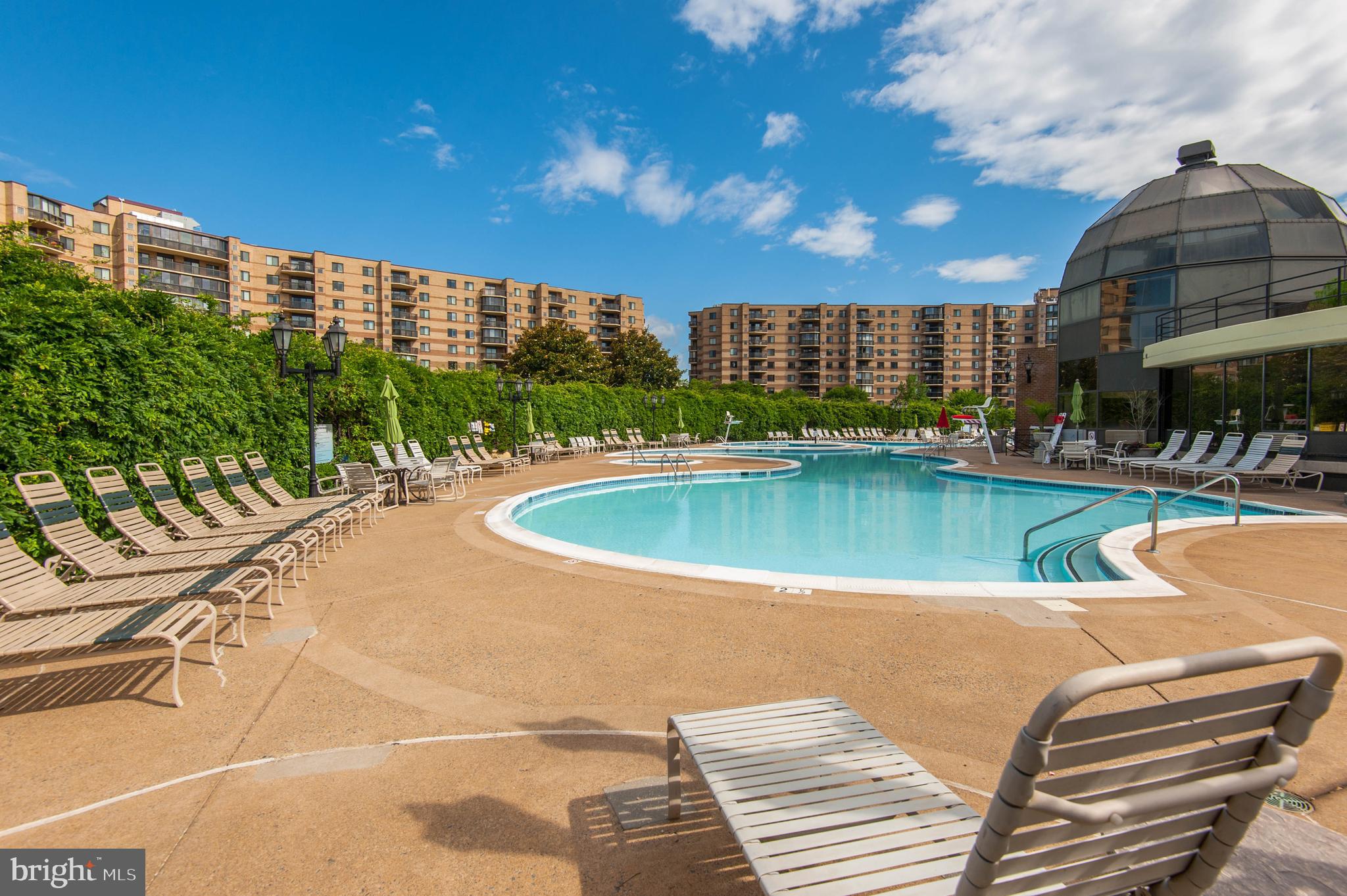 The Rotonda Condominiums
A Gated Community in the Heart of Tyson's, Virginia
The Rotonda is a unique condominium community with a beautiful 34-acre site and easy access to the Tysons, Dulles Corridor, and D.C. business, retail, and employment centers. Five high-rise buildings designed in graceful curves form the primary residential portion of the property; drive circles, landscaping, and fountains create a gracious entryway for residents and their guests.
A multi-million dollar renovation of the Rotonda’s Community Center, the heart of the property, was completed in September 2016. The highlight of this make-over is a 2,000 square-foot, state-of-the-art Fitness Center with a wide range of both cardio and strength equipment. Included is a Yoga Studio. An Indoor Swimming Pool with Spa provides areas for relaxing and swimming, even in the winter. Spas provide luxury bathroom facilities, as well as saunas and private showers/changing areas. Other renovated spaces include a Traditional Game Room featuring foosball, ping-pong, air hockey and pool tables; a Digital Game Room with Xbox and PlayStation systems; and a Business Center with conference equipment for meetings.
Refurbishment of the Mezzanine Level of the Community Center was completed in May 2017. Now enjoyed is a Lobby, where residents and guests will be greeted by staff at the Front Desk and can meet with those from the Association Office; a Lounge area with comfortable seating and a piano, a Library and Social Hub featuring multiple seating areas and tables for gathering with friends of playing games, a multi-purpose room where weekly Chair Yoga and activities take place. All five buildings are currently undergoing carpet and lobby tile replacement, expected to be completed in 2023. 
On-site outdoor amenities include an Outdoor Swimming Pool (open Memorial Day weekend through Labor Day), six lit Tennis Courts, a Basketball Court, a Golf Putting Green, Play Areas, a mini Soccer Field, a Sand Volleyball Court, and more. Behind the residential buildings lies an area of woodlands and greenery, featuring a gazebo that overlooks two ponds, a fitness trail, and walking paths. Several pet-friendly areas, including an off-leash Dog Park, are modeled after Fairfax County’s off-leash dog parks. In 2018, the Rotonda installed community electric vehicle charging stations for the growing number of residents who are choosing electric vehicles. 
Just minutes away are the world-class Tyson's I and Tyson's II malls, as well as many upscale stores and restaurants. Tysons is an established business center slated to become a central East Coast hub within the next 20 years. The Metro arrived in Tyson's in 2014, now connecting the area with Maryland, D.C., and Dulles International Airport. The Rotonda sits between two metro stations on the Silver Line. 
Management has replaced significant systems, including roofs, elevators, and the fire alarm system, to provide residents with spacious floor plans and solid construction, complemented by modern and efficient updates. Enthusiasm is high as management, owners, and residents embark on additional enhancements at the Rotonda and enjoy a metro stop just two blocks away.