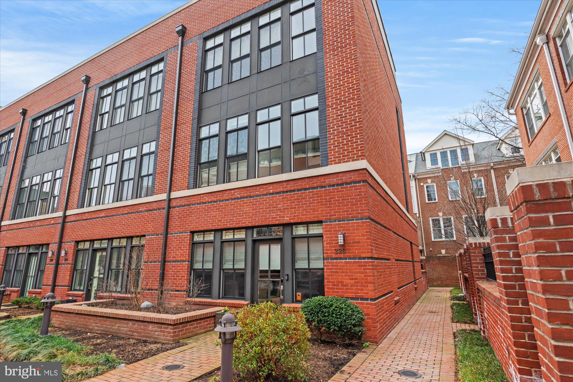 Luxurious living in exclusive Printers Row! This meticulously maintained, end-unit townhome is defined by its modern style, featuring a bright and open main level floor plan, high windows, 10-foot ceilings, and several private outdoor spaces. The spacious main level features an oversized dining space, gorgeous kitchen, a large living room, convenient half bath, pantry, and a private outdoor patio - great for summer BBQs! The kitchen is a chef's dream with quartz counter-tops and island, white subway tile backsplash, ample cabinetry, Wolf gas range, Zephyr hood and Kitchen Aid refrigerator and dishwasher. Head upstairs to the second floor, which is dedicated to the beautiful primary bedroom suite. This serene retreat features a balcony, a spa-like ensuite bath and amazing closet space with customized shelving. The primary bath has a double vanity, walk-in shower and Victoria & Albert bathtub. The third floor boasts two large bedrooms with great closet space, a shared hall bath and laundry. On the fourth floor is a lofted living room with a wet bar. Head outside to the private, two-tiered rooftop deck with views of the Potomac River and DC! This private, gated enclave of North Old Town is situated steps from the Mt. Vernon Trail with access to many restaurants such as Hank’s Oyster Bar, Oak Steak House, Sisters Thai, Café 44 and St. Elmo’s Coffee among others. Trader Joe’s and Harris Teeter are within walking distance, so you can leave the car at home (2 garage spaces - one with an EV charger!). Less than a mile to the Braddock Road Metro, two traffic lights to DC, and a short drive to Reagan National Airport, this home is ideal for commuting! Welcome Home!