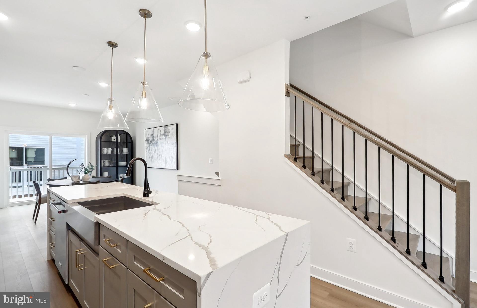 END UNIT.  Brand new with full warranties. Ready for immediate move-in.  This 4-level Baywood Way townhome features 1,791 square feet of space. Lot 01105. This is your all-in price with upgrades already included. This home offers 3 bedrooms, plus 3.5 baths, so each bedroom features its own private bathroom. A 4th floor interior loft area for an additional entertaining space, loft level bedroom with stand-up shower w/ seat, plus a 11’ x 15’-8”’ rooftop terrace for outdoor entertaining or soaking in the sun. Plus, a 2-car tandem garage. The open concept main level features a large center kitchen cascade island, KitchenAid stainless steel appliances, Calacatta Laza Quartz countertops, tile backsplash, and White cushion close kitchen cabinetry. The Primary Suite offers dual walk-in closets and on the same level you will have a spacious secondary bedroom with a spacious walk-in closet and a convenient laundry room with a washer & dryer already installed. All Oak stairs and 7" plank flooring throughout.  Just move-in and enjoy your new home! TO TOUR OUR DECORATED MODEL AND FOR MORE INFOMATION ON THIS HOME, PLEASE VISIT OUR SALES CENTER LOCATED AT - 16144 FREDERICK ROAD ROCKVILLE, MD 20850 Farmstead District in Rockville, MD is a blend of modern living while offering everything right outside your front door. Upscale community amenities await residents—a symphony of convenience and leisure. Imagine living a few blocks from the Shady Grove Metro with easy access points to I-370 and I-270, your daily commute becomes a breeze. The vibrant tapestry of 270 Center, RIO, and Downtown Crown lies just minutes away, inviting you to explore, dine, and savor life’s little pleasures. But it’s not just about proximity; it’s about the rhythm of everyday living. Take a leisurely stroll to Upper Rock Circle, where culinary delights await. Cava, CVS, Mom’s Organic Market, Nums Yums Bakery, Safeway, Coffee republic, Botanero Wine Bar, Nagoya Sushi, and Firehouse Subs. Just outside, you are steps from pickleball, tennis, basketball, the dog park and everything J. T. Stepanek park has to offer! But wait, there’s more—a hidden gem that ties it all together. The Barn, Farmstead District’s community center, offers a modern fitness center, seasonal pool, fire pit, grills, and multiple seating areas. With room for year-round entertaining, the Barn is designed to elevate your everyday living experience