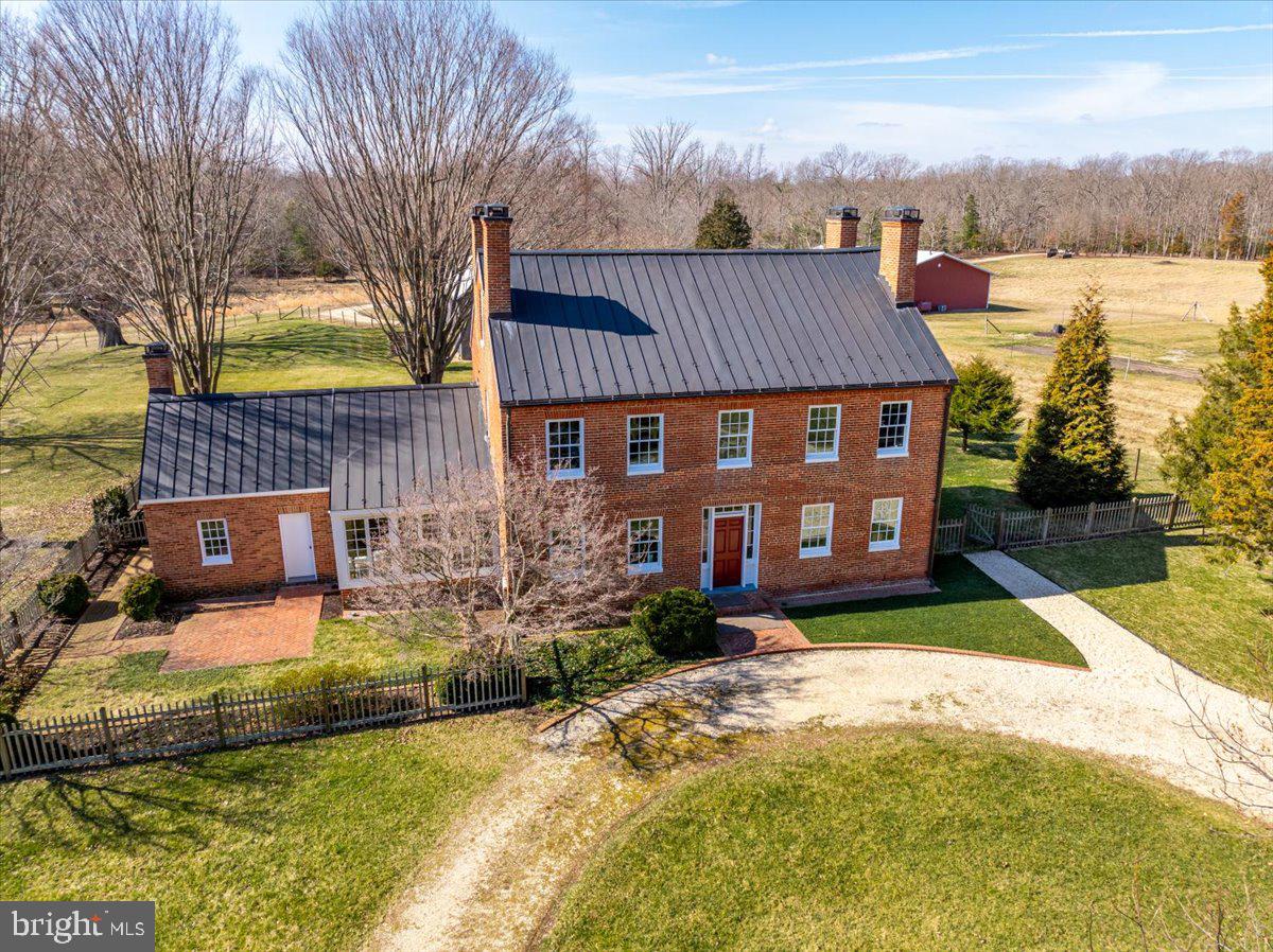 Welcome to Connick's Folly, a stunning piece of history nestled on over 90 acres of pristine land. This magnificent Georgian farmhouse, originally constructed in 1847, has been meticulously restored to its former glory, seamlessly blending timeless elegance with modern amenities. 

Boasting three separate lots, Connick's Folly offers endless possibilities for outdoor enthusiasts. Explore miles of scenic trails perfect for hiking, biking, or horseback riding, immersing yourself in the natural beauty of the surrounding landscape. With 10 cleared acres ideal for farming or ranching, cultivate your own agricultural dreams in this picturesque setting.

The property features three charming barns/utility buildings, providing ample storage space and endless potential for workshops or creative endeavors. Privacy abounds in this tranquil sanctuary, offering a serene escape from the hustle and bustle of everyday life.  Connick's Folly epitomizes sustainable living while preserving the rich ecological diversity of the land. Additionally, with one allowed building site for a second house, the possibilities for expansion or multi-generational living are boundless.   

Experience the timeless allure of Connick's Folly – where history, nature, and modern luxury converge to create a truly exceptional estate. Embrace a lifestyle of unparalleled beauty and tranquility in this iconic 19th-century masterpiece.