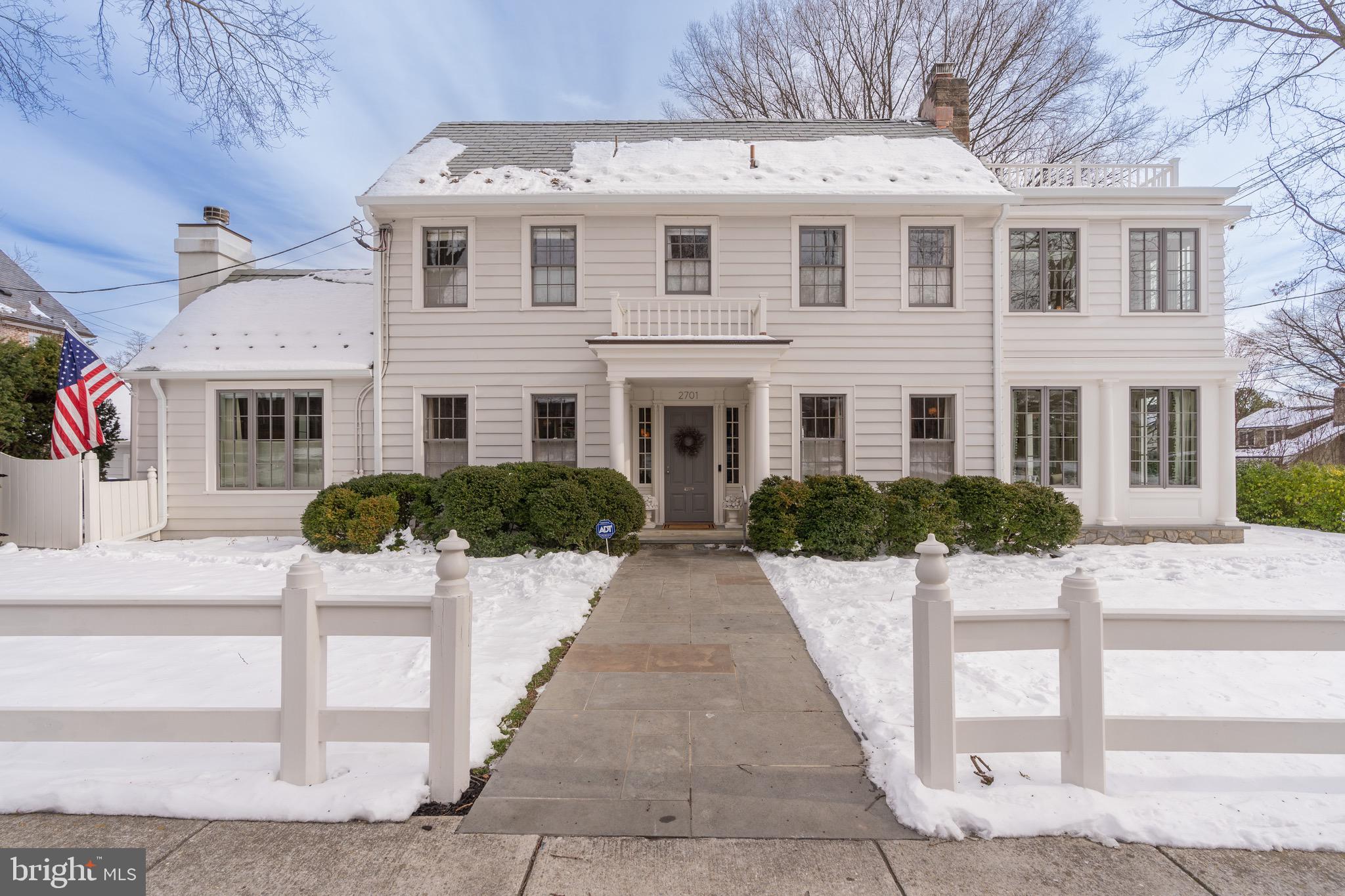 Spanning over 5,100 square feet, this elegant home blends classic architecture with a modern aesthetic and conveniences. Bathed in natural light from 80 windows, 21 glass exterior doors, and 14 skylights, the sun-drenched living spaces and thoughtfully designed floorplan offer seamless flow and sightlines between generously proportioned rooms. High ceilings, crown molding, wainscoting, warm hardwood floors, built-in audio, and heated floors enhance the refined interior. The main level offers a welcoming foyer, two fireplaces, formal living and dining rooms, a grand south-facing sunroom, and a chef’s kitchen with professional-grade appliances and a marble island, flowing into a skylit family room. Upstairs, the primary suite is a luxurious nearly 900-square-foot retreat with a skylit marble bath, walk-in closet, and private office with a relaxing media room. Two additional bedrooms share a Jack-and-Jill bath, with another full bath completing the floor. The sunny third level features panoramic views, a versatile bedroom, and sitting areas with an en-suite bath, including access to a serene rooftop retreat. The lower level has a private walkway and entrance and includes a fifth bedroom, full bath, and a sunny recreation room that opens onto a flagstone patio. Laundry areas on three floors, four HVAC systems, and cast-iron baseboard radiant heat add to the comfort and convenience of this home. This home boasts superb indoor-outdoor flow, with numerous hardscaped patios and lush gardens framed by exquisite mature plantings. A detached two-car garage, 16-zone sprinkler system, and a brand-new slate roof complete the package. Located on a lush, quiet corner lot in Observatory Circle, this home is within walking distance to top schools, parks, grocery stores such as Whole Foods and Trader Joe’s, restaurants, and fitness studios like Orange Theory and CorePower Yoga. It is also ideally situated near Rock Creek Park, Embassies, The White House, Capitol Hill, and downtown Washington, DC. This is a home without compromise.