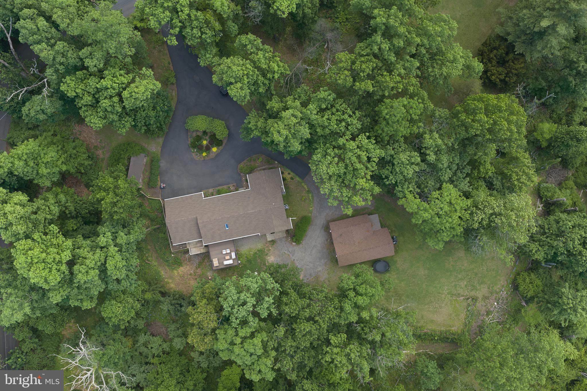6683 Chapel Road offers the rare combination of a completely renovated home with the charm and setting of a classic Solebury rancher — all just minutes from downtown New Hope. Tucked along a quiet stretch of Chapel Road and surrounded by mature trees, this beautifully updated property delivers privacy, flexibility, and modern comfort in a serene natural setting.

Thoughtfully redesigned from top to bottom, the home features 3 bedrooms, 4 full bathrooms, a dedicated office, media room, full finished walkout lower level, and extensive upgrades throughout, including a new roof, soffits, gutters, TimberTech deck, updated HVAC and mechanical systems, upgraded electrical, recessed LED lighting, and new Anderson windows and doors throughout both levels of the home.

The main level is centered around a bright open-concept living, dining, and kitchen space designed for both everyday living and entertaining. Upon entering, the home unfolds into one expansive great room filled with oversized rear-facing windows that flood the space with natural light and frame peaceful backyard views. An original stone fireplace anchors the living space, blending timeless character with the home’s modern renovations. A welcoming entry nook adds warmth and functionality, while the seamless flow of the main living areas creates an airy and inviting atmosphere.

The beautifully renovated kitchen features custom Shiloh cherry cabinetry, luxury Jenn-Air built-in refrigeration, and upgraded appliances designed for both everyday living and elevated entertaining.

The primary suite serves as a peaceful retreat with tranquil backyard views, a beautifully updated bath featuring high-end Porcelanosa finishes, a double vanity, oversized shower, and abundant natural light, along with a generous walk-in closet complete with laundry hookups for optional main-level laundry convenience. A full hall bath with tub serves the additional main-level bedroom and office areas.

The fully finished walkout lower level offers exceptional versatility with 9+ foot ceilings, recessed lighting, and a full wall of sliding glass doors opening directly to the backyard. A spacious secondary living area anchored by a pellet stove creates an inviting extension of the home, while two additional bedrooms — including one with an ensuite bath — provide excellent flexibility for guests, extended family, or multigenerational living. The lower level bathrooms were fully renovated with high-quality Porcelanosa fittings and tile, custom shower enclosures, and thoughtful luxury finishes throughout. A dedicated media room with in-wall speaker wiring, oversized laundry room, and additional full bath further enhance the functionality of the space.

Outside, the property continues to impress with peaceful outdoor living spaces surrounded by mature landscaping and wooded views. A new TimberTech deck extends from the main level, offering the perfect setting for morning coffee or evening relaxation overlooking the private grounds. Set apart from the home, the detached barn sits beside a large flat grassy field perched atop a gentle bluff with seasonal long-range winter views through the trees — ideal for storage, workshop use, hobbies, or future possibilities. An attached two-car garage and expansive parking areas provide ample space for guests, recreational vehicles, or multiple-car households.

6683 Chapel Road is a rare opportunity to enjoy fully modernized living while still embracing the timeless character and peaceful setting that define Solebury Township.

Special Financing Incentives available on this property from SIRVA Mortgage. See documents for more information.