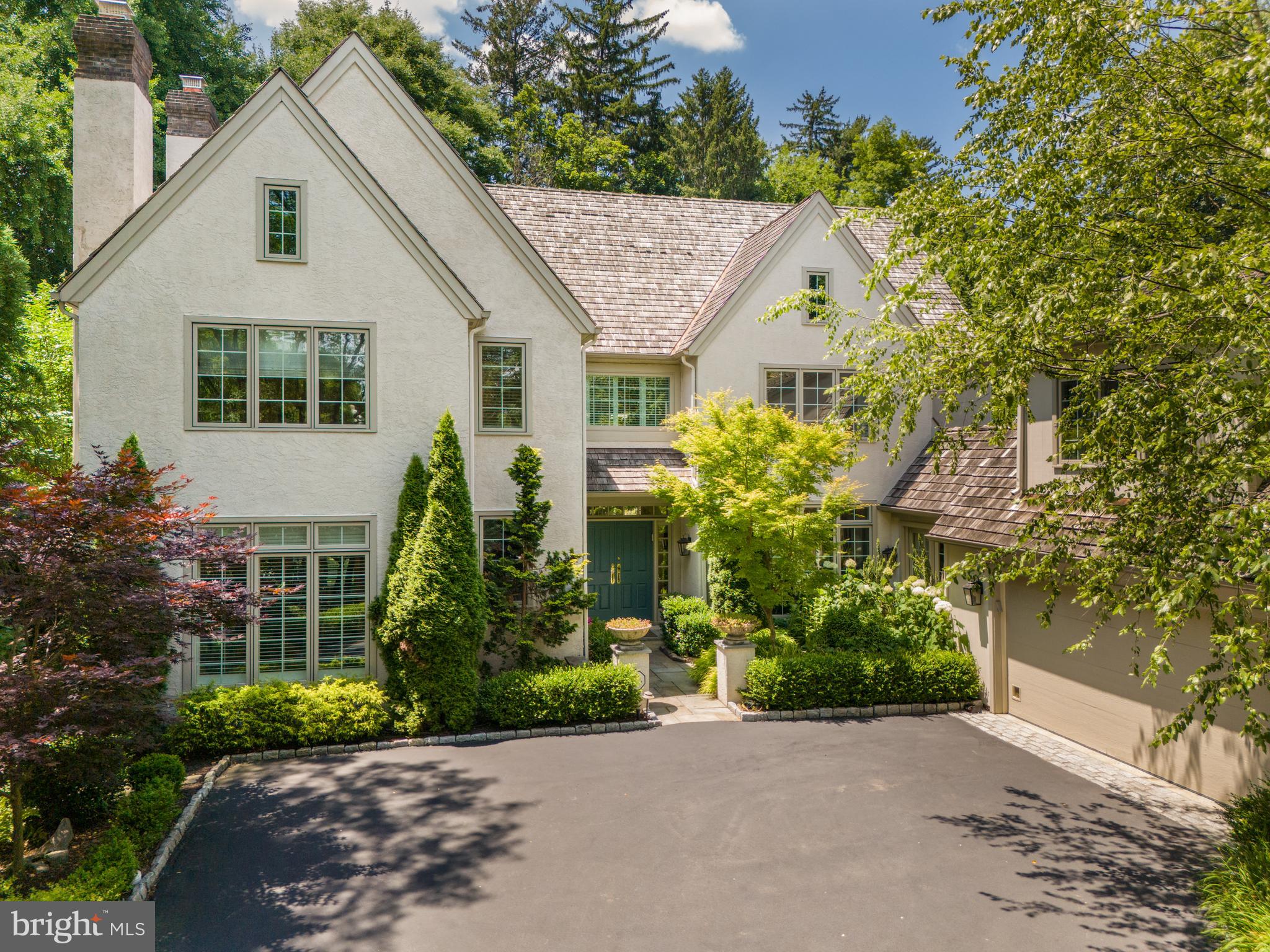 Welcome to 1222 Denbigh Lane, an exquisite 5-bedroom, 4.5-bathroom English Country style home located in the prestigious Denbigh Estates Community. This remarkable residence is surrounded by acres of open space and scenic trails, offering an unparalleled living experience. With its refined architecture, artisanal craftsmanship, and exceptional interior design, this home epitomizes elegance and sophistication.

Upon arrival, you are greeted by a professionally landscaped grand entrance, featuring vibrant garden beds and meticulously maintained hedges lining the winding driveway. A paver walkway leads to the covered front entrance, setting the tone for the elegance within. Step through the double doors into a vast two-story foyer, adorned with gleaming hardwood floors and tasteful crown molding. To your left, the elegant living room is decorated with a marble surround gas-burning fireplace with a wooden mantle, custom built-ins, two discerning chandeliers, a magnificent built-in fish tank, and crown molding. The living room opens to the expansive rear patio through glass French doors, creating a seamless transition between indoor and outdoor living spaces.

Opposite the foyer, the formal dining room boasts custom built-ins, hardwood flooring, and crown molding. Nestled at the back of the home is your gourmet eat-in kitchen, showcasing sleek quartzite countertops with a Sri Lankan Volcanic Stone backsplash, commercial-grade appliances including three refrigerators, an abundance of custom wooden cabinetry, a large center island with barstool seating and a secondary sink, an expansive pantry, and a baking/coffee bar for added convenience. The hardwood flooring leads to the breakfast room, offering oversized windows that provide captivating views of the serene waterfall.

Open to the kitchen and breakfast area, the magnificent great room features an ultra-high ceiling, a marble-surround gas fireplace, custom floating wooden cabinets, a custom built-in bar with two wine fridges, and glass french doors that provide direct access to the rear yard. The first floor is completed with two-car heated garage access, a tiled mudroom with heated floors, a recently upgraded powder room, and additional space with a fireplace, ideal for a fitness studio or office.

Ascend the grand front staircase to the second floor to find the primary suite, masterfully detailed with hardwood flooring, dual walk-in closets, and recessed lighting. The spa-like exclusive ensuite bath is equipped with heated floors, a dual vanity, a soaking tub, a glass-enclosed tiled shower, and a remote-controlled Toto toilet. Three additional bedrooms, each with hardwood flooring and ample closet space, share a tastefully updated full hall bathroom with heated floors. The fifth bedroom is an ensuite, accessed by a private staircase off of the mudroom area, featuring a large closet and its own private bathroom with heated floors.

The substantial lower level is perfect for hosting gatherings, offering a custom in-home movie theater with seven leather reclining seats, an immense flex space that can accommodate a bedroom or office area, a fully updated bathroom, an abundance of storage opportunities, a large tiled laundry room with a utility sink, and a woodshop.

The exquisite, tree-lined rear yard is a true masterpiece of outdoor living. Featuring a custom flagstone patio perfect for hosting unforgettable gatherings, this lush oasis is adorned with meticulously maintained garden beds and a stunning, elegant waterfall. This enchanting setting provides an unparalleled backdrop for entertaining in style and sophistication.

This exquisite residence at 1222 Denbigh Lane epitomizes elegance and luxury, offering an unparalleled living experience in the heart of Wayne, PA. Situated in the prestigious Denbigh Estates Community, this home enjoys a prime location that balances serene privacy with convenient access to top-tier amenities.