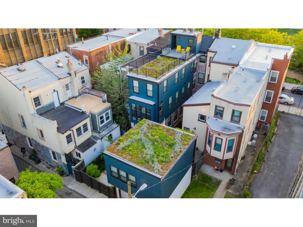 Painstakingly and lovingly restored custom 4 story, 5 bedroom, 3 bath home (plus new construction 1 bedroom/1 bath carriage house/in-law suite), located on picturesque Hawthorne park in a safe, welcoming neighborhood. L-shaped property spans two blocks front-to-back and encompasses three consolidated lots. Approximately 4,000 interior square feet (including 920 square foot finished basement with 8 foot ceilings) plus an additional 400 square feet in the carriage house. Tax abatement in effect through 2026. Located three blocks from Whole Foods, ACME, and CVS; a stone's throw from the famed 9th street market; surrounded on all sides by parks and playgrounds. Three blocks from PATCO line. All the comforts of new construction with the quality and personality of the original home. Original red pine hardwood floors and original spiral staircase. Exposed brick throughout. Junior 1 bedroom/1 bath carriage house above garage (zoned for multi-family - rental income opportunity), with separate entrance, separate alarm system, hardwood floors, washer/dryer, heated bathroom floors, Hunter Douglas custom blinds, quartz countertops. Two-car garage with Elfa storage system, lush garden with mature landscaping, three no-maintenance green roofs, roof deck with unobstructed view of Philadelphia skyline. Wine cellar with 620 bottle capacity. Custom mudroom with expansive and flexible storage opportunities. Floor to ceiling Poggenpohl kitchen cabinets, Sub Zero refrigerator and LaCornue 42" double-oven range; quartz countertops. Sunroom with indoor commercial-grade grill and commercial ventilation system. In-ceiling speaker system throughout " can be controlled by smart phones and zoned to play different music in each room simultaneously. Two fireplaces " one gas and one wood-burning. Finished basement with 8' ceilings, with heated stained concrete floors, with: large storage room, server room, laundry room and laundry chute (spans third floor to basement), climbing wall and ceiling anchors for play equipment.