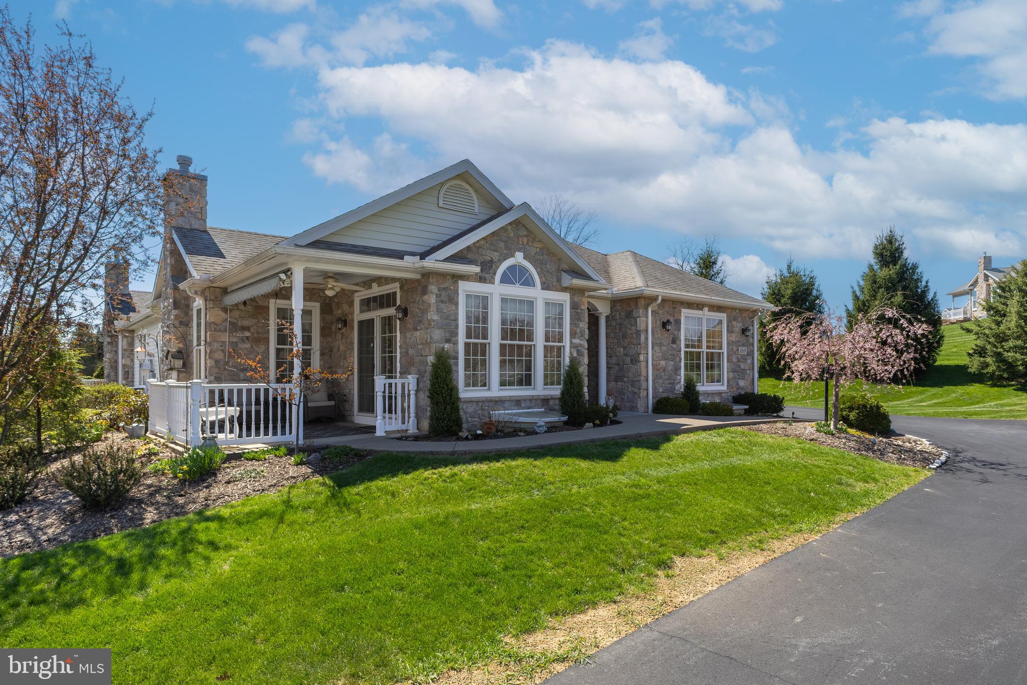 A wonderful opportunity to own a spacious condominium in the only duplex at The Glenn at Paradise Hills, located in the heart of Central Pennsylvania. This thoughtfully designed home offers over 2,600 square feet of living space, featuring four bedrooms and three full bathrooms. The main level includes two bedrooms and two full baths, along with an open-concept layout that creates a comfortable and functional living environment. The lower level provides additional flexibility with another 2 bedrooms, full bath, and partially finished basement space suitable for a variety of uses. Interior highlights include hardwood flooring throughout the main living areas, a striking floor-to-ceiling stone fireplace, and a well-appointed kitchen complete with cherry cabinetry, granite countertops, ceramic tile backsplash, and stainless-steel appliances. A sunroom off the main living area offers a bright and inviting space and opens to a patio with sun setter awnings for outdoor enjoyment. Additional features include a two-car garage and convenient access to nearby amenities and a 2nd side patio for enjoyment and entertaining. The property is located just minutes from downtown Bellefonte and approximately 15 minutes from downtown State College, offering easy access to shopping, dining, and recreational opportunities.