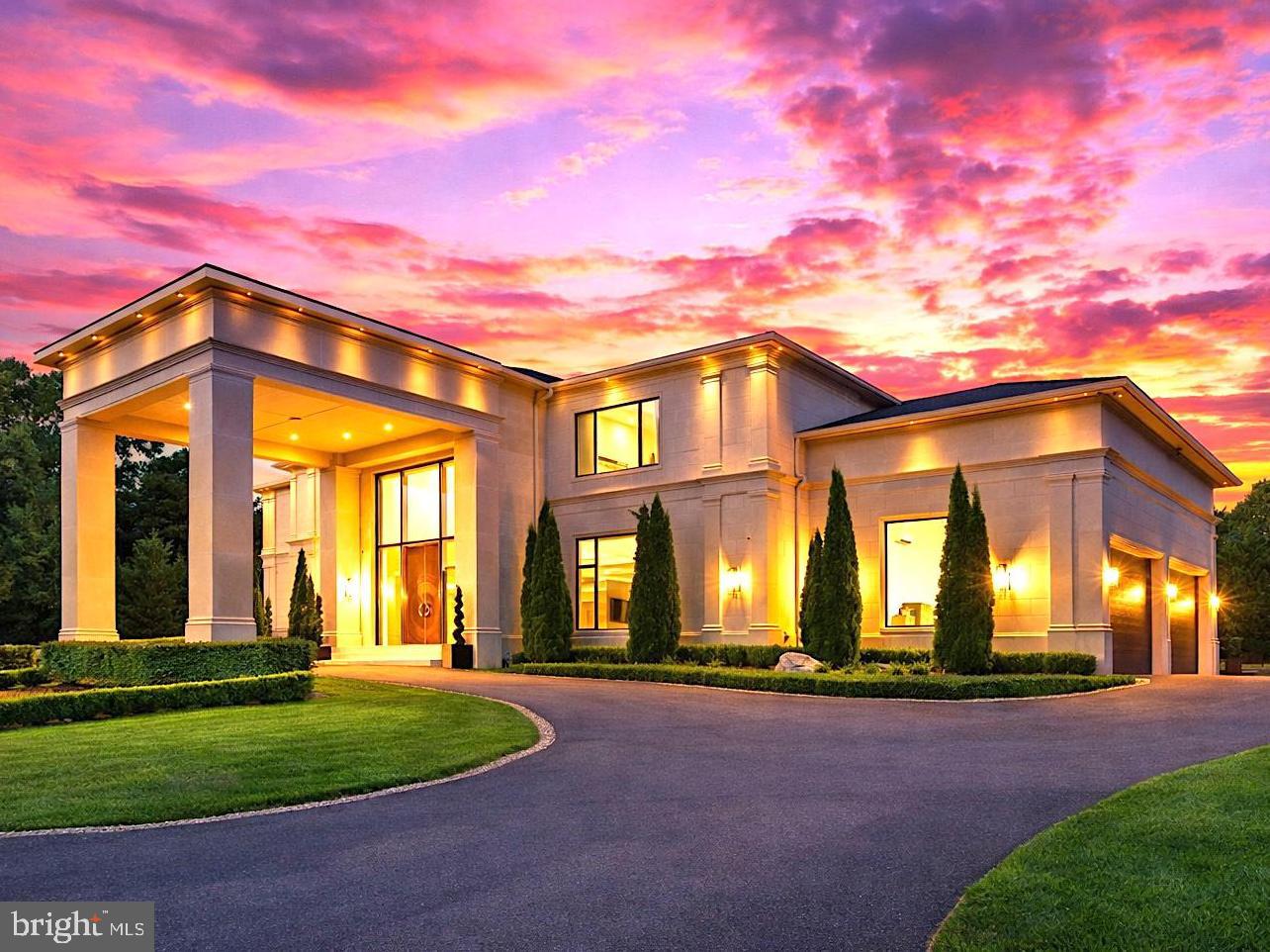 Introducing 8880 Bradley Blvd, a striking contemporary estate set on a fully gated two-acre parcel in one of Bethesda’s most prestigious enclaves. Designed for those who value architectural distinction, privacy, and resort-caliber living, this extraordinary residence offers approximately 13,750 square feet across three levels, with 7 bedrooms, 7 full baths, 2 half baths, and a custom hydraulic elevator serving every floor.

From the moment of arrival, the estate makes a commanding impression. An app-controlled arched iron gate opens to a long, scenic approach, culminating in a circular motor court, manicured grounds, and a custom Italian bronze entry door. Inside, the dramatic foyer rises to 24-foot ceilings and is crowned by a sculptural custom light installation by Cameron Design of London, setting the tone for the home’s bold modern aesthetic and refined craftsmanship.

Created for both grand entertaining and seamless daily living, the residence showcases expansive interiors, clean architectural lines, sophisticated finishes, and state-of-the-art smart home integration. The main kitchen is appointed with commercial-grade appliances and exceptional workspace, while a separate scullery kitchen with its own entrance provides ideal support for catered events, staff, or effortless everyday functionality.

The home’s lower level delivers a true private wellness and entertainment retreat. Thoughtfully designed for leisure at the highest level, it features a Turkish bath with separate warm room and heated marble surfaces, a fully equipped fitness studio, state-of-the-art theater, wine and cigar lounge, and an additional kitchenette with full-size refrigerator, dishwasher, and microwave.

Upstairs, the private quarters continue the home’s sense of elevated comfort and calm. The owner’s suite is a sanctuary unto itself, complete with a spa-inspired bath with heated floors, an expansive two-room dressing area, and a serene sitting room with morning bar. Each secondary bedroom is generously scaled and beautifully appointed.

The exterior amenities rival those of a luxury resort. Framed by mature trees for exceptional privacy, the outdoor living environment includes a saltwater pool with infinity edge, mosaic-tiled spa, four gas fire pits, and a cabana pavilion with outdoor kitchen, fireplace, and generous entertaining areas. Whether envisioned as a private family compound, ambassadorial residence, or executive retreat, the estate offers a rare combination of grandeur and seclusion.

A four-car attached garage with Porsche charging station, basketball hoop, and air conditioning adds further convenience. Throughout the home, remote-controlled window treatments, expansive windows, whole-house soundproofing and insulation, central vacuum, app-controlled surround sound, advanced security, five commercial-grade HVAC systems, two 75-gallon hot water tanks, and generator backup underscore the property’s exceptional infrastructure and readiness.

Only minutes from the finest golf, acclaimed schools, upscale shopping, fine dining, and the heart of Washington, D.C., 8880 Bradley Blvd offers a lifestyle that is at once prestigious, private, and profoundly peaceful. Whether serving as a family legacy property, an ambassadorial residence, or a refined executive escape, this remarkable estate captures the essence of modern luxury—where striking design, uncompromising privacy, and the ease of a five-star resort are woven into everyday life.