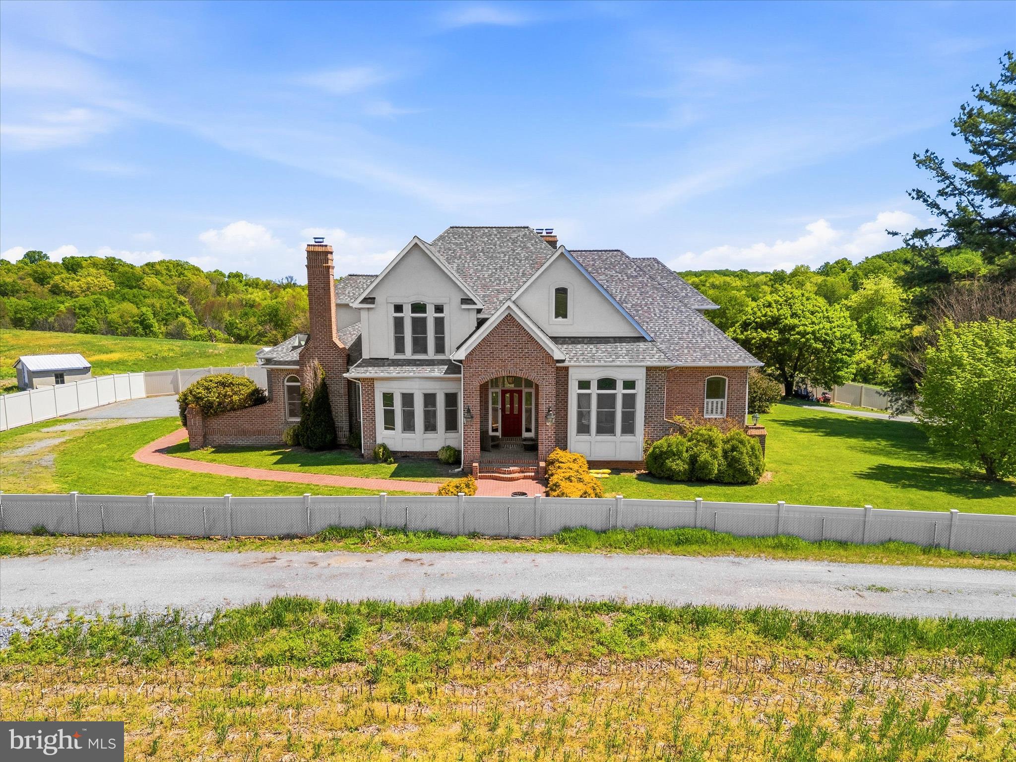 Nestled at the heart of a breathtaking 139-acre farm, this stately all-brick residence offers a rare opportunity to own a private one-acre homesite surrounded by rolling countryside, mature trees, and serene farmland views. The home is being offered separately from the adjoining 139-acre farm, with both properties available for purchase—an ideal scenario for a buyer seeking a legacy estate, equestrian property, or ultimate privacy. Both sellers are open to a combined sale or separate purchases.

This expansive custom home features 4 bedrooms, 6 full bathrooms, and 2 half bathrooms, including a desirable main-level primary suite designed for comfort and convenience. The thoughtfully designed layout showcases spacious rooms throughout, generously sized bedrooms all with ensuite bathrooms and walk-in closets, providing exceptional storage and a sense of openness ideal for both everyday living. There is a very large room above the garage that could be used as a 5th bedroom. The home is further highlighted by two fireplaces on the main level and an additional fireplace in the fully finished basement.

The lower level includes a separate kitchen, offering excellent flexibility for multi-generational living, guests, or private entertaining space. Additional updates include a new roof (2024) and a fully fenced yard with a new fence, providing both peace of mind and privacy.

Car enthusiasts and hobbyists will appreciate the oversized garage with doors on both sides, along with abundant parking for multiple vehicles and guests. The property is enhanced by mature trees, established landscaping, and expansive outdoor space, creating a park-like setting that feels secluded yet connected.

Located in a highly sought-after area with top-rated schools, the home is just minutes from major commuter routes, shopping, dining, and everyday conveniences—offering the perfect balance of rural charm and accessibility.

Whether purchased on its own or together with the surrounding 139-acre farm, this is a truly special offering with endless possibilities. A rare chance to secure a private estate setting in one of Sykesville’s most desirable locations. (139 Acres Farm listing # MDHW2063424 - 13090 Old Frederick Rd, Sykesville, MD 21784 )