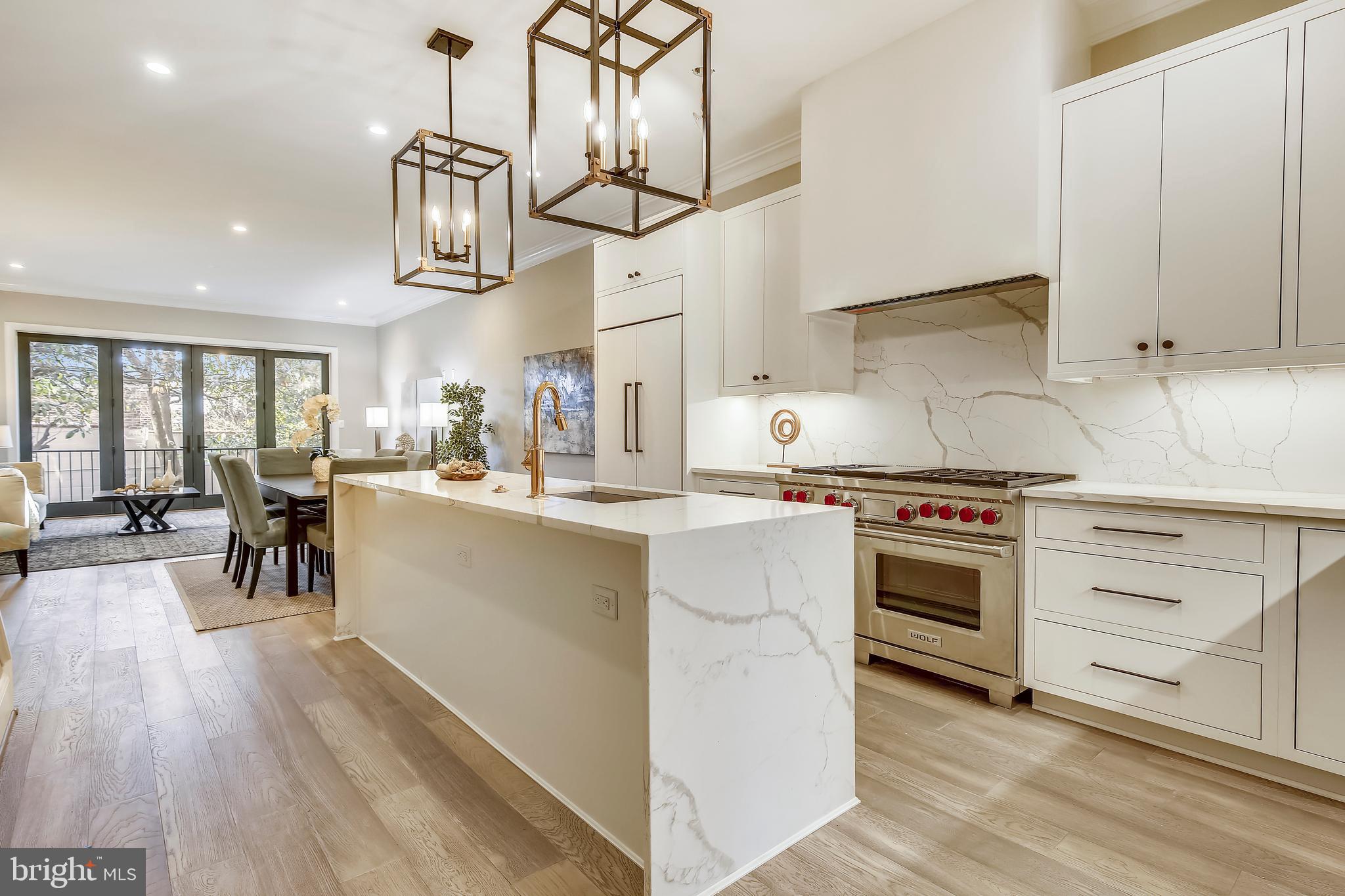 Newly-renovated 3 or 4-bedroom 3.5-bathroom stunner, expanding 3,240sf, on a block embracing historic character! The open and flowing main floor invites lingering. The exquisite, white kitchen offers an island of Calacatta quartz,  Subzero and Wolf appliances.  In addition to a welcoming living room and formal dining room is a main-floor family room with serene views of a magnolia tree and garden. On the second level are 2 bedroom SUITES, each with bathrooms, PLUS a study/guest room. Romantic balcony off the master bedroom! The high-ceilinged walk-out basement includes a bonus SECOND family room, wet bar, bedroom/bathroom suite, AND a powder room. Two sets washer/dryer. Two wine refrigerators. The private patio and backyard leads to two-car gated parking. Seconds to Georgetown's Wisconsin Avenue and M Street retail mecca! Check out Walk-Through Video in Virtual Tour Tab!