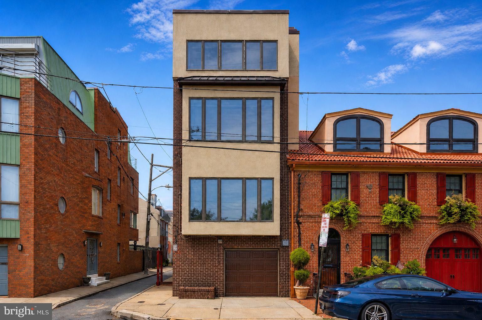 Welcome to 730 South Front Street,  a rare opportunity to own an expansive four-story corner residence in the highly sought-after Queen Village neighborhood, located within the award-winning Meredith School catchment.

Offering over 4,200 square feet, this impressive 5-bedroom, 4.5-bath home features two-car parking, an elevator, an in-ground pool (please read below for details), and breathtaking river and city views throughout. The open floor plan is complemented by soaring ceilings, hardwood floors, and walls of windows that flood the home with natural light.

The first floor welcomes you with a spacious entry hall providing direct access to the garage, a convenient powder room, and a versatile den/sitting room complete with a fireplace and French doors leading to a private outdoor space with a second parking spot.

The second floor is truly the heart of the home, an expansive, open-concept living and entertaining space surrounded by windows with stunning river and park views. This level includes a generous living room, a sizable dining area, and a chef’s kitchen outfitted with stainless steel appliances, granite countertops, abundant cabinetry, a large island, and a separate breakfast room.

Upstairs, the third floor offers a serene primary suite with beautiful river views and a marble bath, along with two additional well-sized bedrooms and a full hall bath.

The fourth floor, added in 2007, features a luxurious primary suite with an entire wall of windows showcasing spectacular river and Penn's Landing views, along with a spa-like marble bath with frameless glass shower and a large walk-in closet. An additional bright rear bedroom with windows surround offers wonderful Center City skyline views, completing this level.

An in-ground pool located directly behind the property sits on a separate deed (approx. 16' x 51') and is not included in the sale. The pool/lot may be purchased in conjunction with the home for an additional price (call for details). The seller will not sell the pool/lot separately prior to the sale of the residence; however, it may be made available after the home sale if the purchaser elects not to acquire it.

With incredible space, flexible living areas including a den, sitting room, office, and unbeatable views, this home offers the perfect blend of luxury and functionality, all in one of Philadelphia’s most desirable neighborhoods.

Schedule your private tour today and experience this exceptional residence firsthand.