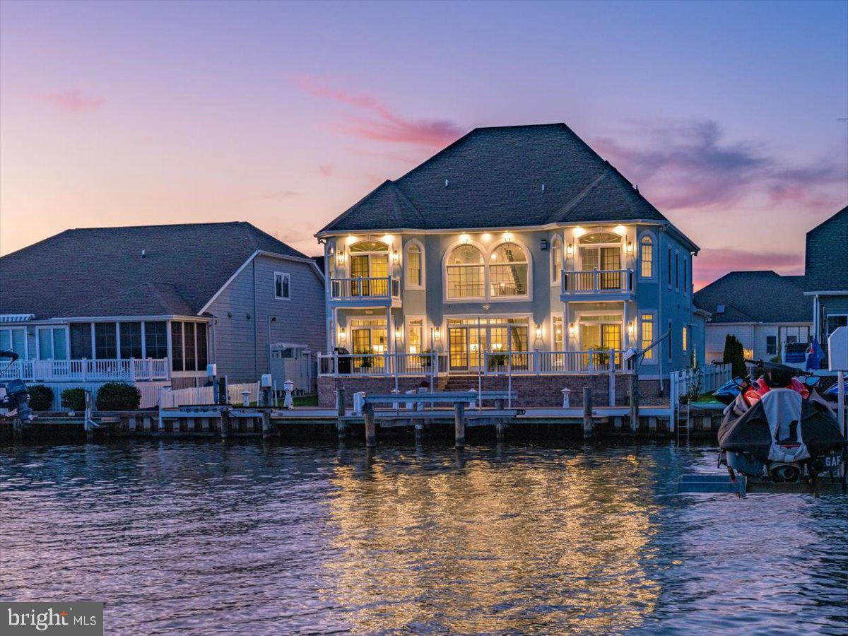 This stunning coastal custom recently renovated 6BR/6BA/2HBA waterfront estate in Ocean City, Maryland has just been listed.  Immerse yourself in the ambience of this luxurious waterfront lifestyle while enjoying breathtaking views of the water. This property features exceptional craftsmanship with astute attention to detail. This home is built for the sophisticated buyer looking for custom finishes, efficiency and a touch of class. There is plenty of space for family and friends with six spacious bedrooms with six master suites. The first-floor master bedroom overlooks the water and has a luxurious master bath.  You can enjoy morning coffee on the waterfront patio adjoining the master bedroom. The incredible spacious kitchen features granite countertops, two sinks, high end appliances, upgraded cabinets and many other extraordinary details. The dining area is off the kitchen and overlooks the water. The family room is off the dining room and also overlooks the water. The family room has soaring 22-foot ceilings and a gas fireplace making it the perfect place for year-round enjoyment.  There is a sunroom or office area off the front of the house which could also be used as a separate dining room.  On the third floor you will find a movie theater room with kitchen.  This home truly has it all.   The house has an abundance of natural light and southern exposure.   You will enjoy watching the boats go by and the breathtaking bay views and sunsets. Additional enhancements include upgraded lighting and flooring, 2- 75-gallon water heaters and 3 zone heating and air conditioning.  Enjoy outdoor living with the extensive composite multi-level decks perfect for summertime barbecues, parties, crab feasts, entertaining and relaxing. There is a private pier with a deep-water dock, 10,000-pound boat lift, two jet ski lifts, a davit hoist and vinyl bulkhead. The home was professionally landscaped and has an irrigation system.  This estate offers a fabulous open floor plan that maximizes spectacular views and is a short distance to the beach, shops and many restaurants.  Boasting over 5200 sq ft, this home is in the amenity rich community of Heron Harbour. The community amenities include an indoor heated pool, outdoor family pool, Olympic size lap pool, kiddie pool, fitness center, library, social room and two lighted clay tennis courts. This is more than a luxurious home, it's a wonderful lifestyle.