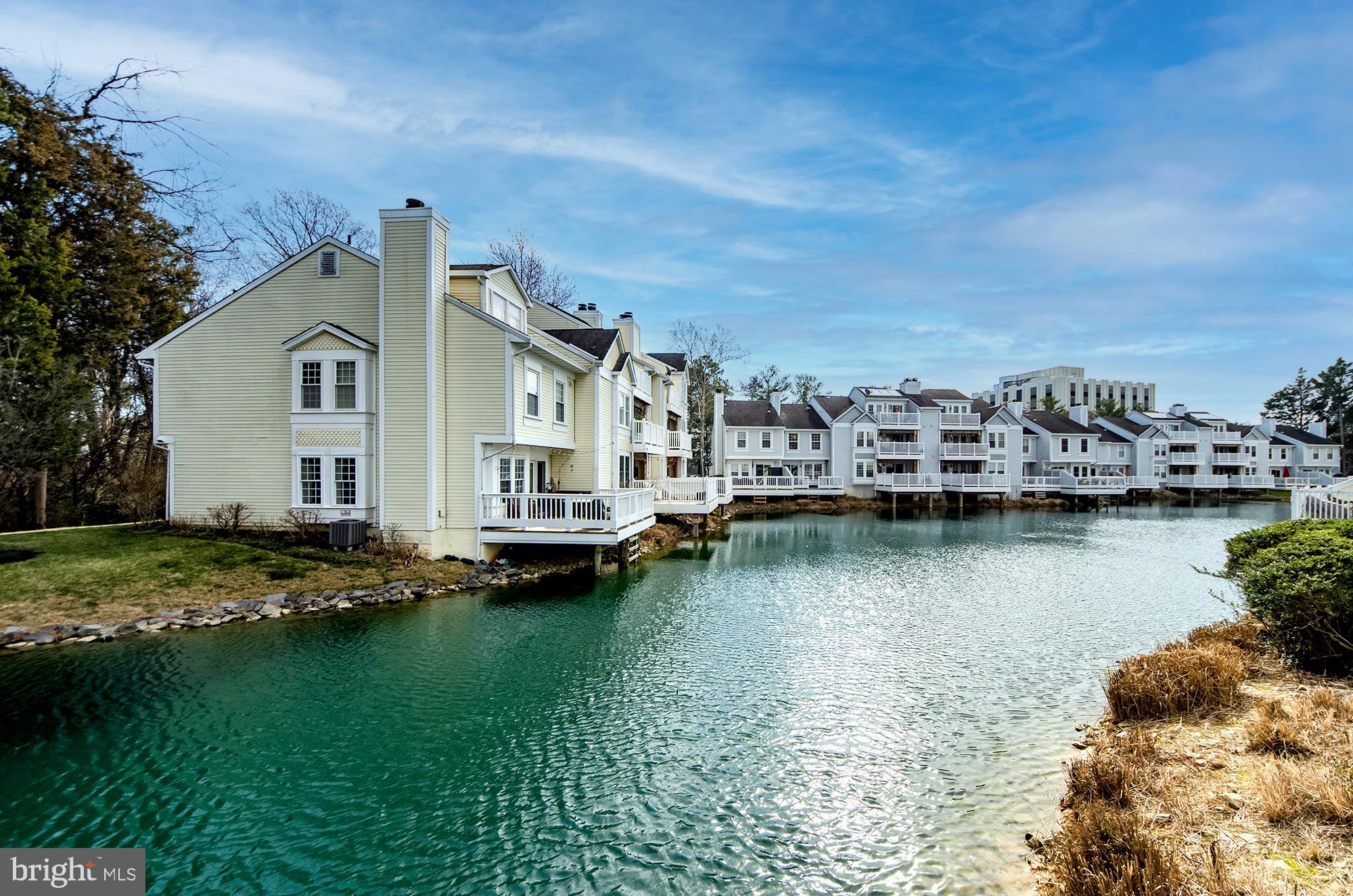 Open House on Saturday from 11-12:30 for potential tenants. Charming waterfront oasis in the heart of Falls Church!  Beautifully updated and ready for immediate move-in!   This incredible 2 bedroom, 2.5 bath end unit townhouse backs to a private, serene lake with stunning turquoise water.   The main level enjoys an open floor plan with unobstructed water views out the rear sliding glass doors opening to an expansive deck; a perfect spot for morning coffee or an evening nightcap by the water. The updated kitchen features new stainless steel appliances, granite counter tops and excellent storage, and opens onto the dining  & living areas with a cozy fireplace and a half bath to round out the conveniences.  The upper level offers two spacious bedrooms, each with its own bath (one is en suite and one is accessed via the hallway), and double closets.  A discreet laundry area is tucked away at the top of the stairs as well!  1 assigned parking spot located just steps to the front door and plenty of open parking to accommodate your needs.
With its fantastic location, this townhouse offers the best of both worlds with an easy commute throughout Northern Virginia and DC, but also nestled away from the bustle of the city.  Enjoy gorgeous lake views from your private deck, unwind with a stroll around the water on lovely walking trails, or take advantage of the pool and tennis courts; this community is truly a rare find!