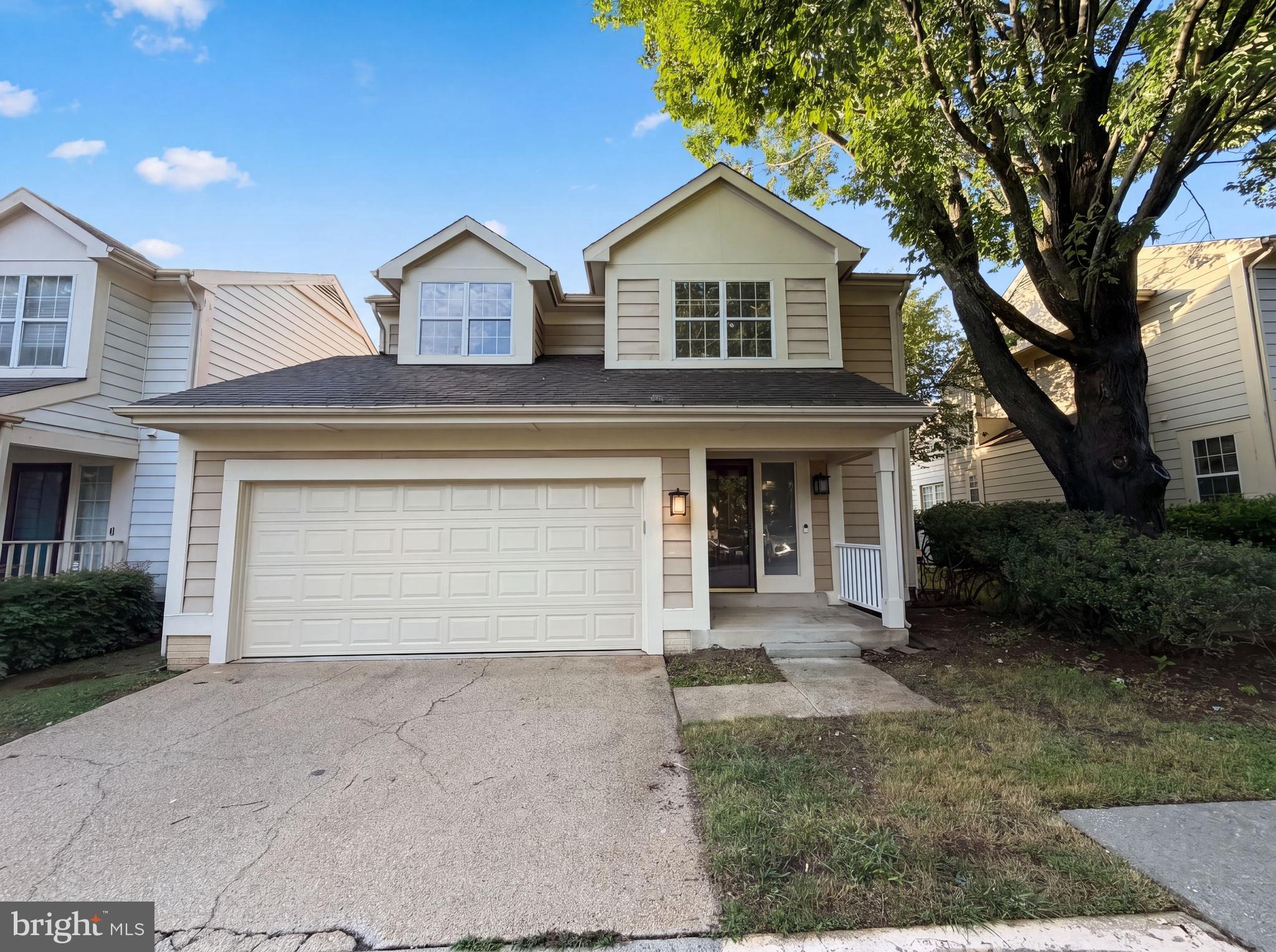 Two-story colonial-style home in Montgomery Village offering a functional layout across three finished levels. The updated kitchen features oak cabinetry, granite countertops, stainless steel appliances including a refrigerator and dishwasher, and tile flooring. The main living area boasts vaulted ceilings, a wood-burning fireplace, and hardwood flooring, with a sliding glass door leading to the rear deck. A second living space on the main level offers additional flex space. The upper level includes multiple carpeted bedrooms with ceiling fans, a full bath with double vanity and soaking tub, and a full hall bath with tub/shower combo. The finished lower level provides a spacious bonus room with recessed lighting and new carpet. A two-car garage and in-unit laundry complete the home. Out back, a wood deck overlooks a fenced yard bordered by mature trees.. Included 100-Day Home Warranty with buyer activation