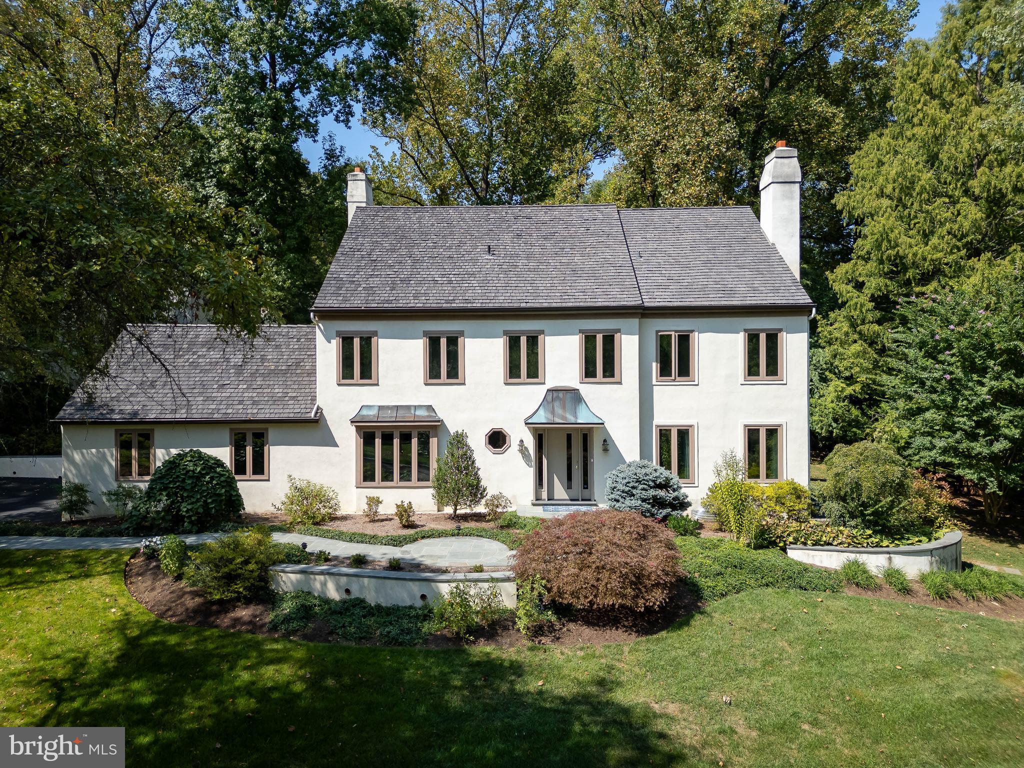 I am excited to bring you a fabulous, updated, spacious home in Round Hill, the neighborhood I call Ravenscliff II, one of the best kept secrets in Wayne, Radnor Township. Welcome to 419 Round Hill Road! This lovely 4-bedroom, 3 full 2 half bath home boasts a generous 5,182 square feet of comfortable living space sitting perfectly on its 0.9 acre fenced yard.
Step inside to be greeted by an unusually large front entry foyer with a coat closet and formal powder room. To the right, the formal living room features large casement windows and a wood-burning fireplace providing warmth and stunning views throughout the seasons. Continue to the traditional dining room perfect special occasion meals and celebrations.
 The heart of the home is the thoughtfully designed kitchen, renovated in 2021. This expanded space accommodates a generous cooking area with an oversized granite island and an eat-in area for a large table and chairs. Outstanding features include pristine wood custom cabinetry, stainless steel appliances including a Miele dual fuel range, powerful Thermador extractor fan, Miele dishwasher, KitchenAid warming drawer, LG French door refrigerator, and GE 240V Advantium microwave/halogen oven.
A large picture window with side flanker panes overlooks the lush backyard, The window provides abundant natural light, enhancing the kitchen aesthetics. An open space concept connects the kitchen to the adjacent family room with gas fireplace and to the flagstone patio. How perfect for mingling and keeping the cook engaged!
For those working from home, a private office off the family room offers built-in bookcases and ample space for desks and equipment. The first floor also includes a mudroom with a coat closet, more storage and a doggy shower. In the mudroom there is inside access to the attached oversized two car garage. 
The second floor features a beautiful master bedroom suite with a sitting area and updated master bath, complete with a steam shower, double sink vanity and private commode. The master suite also has two ample outfitted walk-in closets. There are two other large 2nd floor bedrooms with double closets which share a stylish bathroom with tub shower combination. The second-floor laundry room is equipped with an LG front load washer and Whirlpool electric dryer. The third floor consists of an expansive fourth bedroom with ensuite full bathroom that is ideal for teenagers or guests; as well as a doored off unfinished storage space.
The finished lower level is truly impressive, featuring a built-in bar with full sized dishwasher, recreation area with a SONY 75-inch flat-screen TV & A/V system, a powder room, a craft room and a second kitchen with Bosch electric oven, gas cooktop, warming drawer, Samsung French door refrigerator. Moreover, there is a temperature controlled wine cellar. The lower-level walks out to the side yard perfect for setting up a table and chairs for an additional outdoor relaxing area.
Cherished by its current owners for over 30 years, this home exudes warmth and positive energy. Nestled in a historically significant neighborhood, it was once part of the grand Ravenscliff Estate, renowned for its majestic mansion and expansive grounds that echo the elegance of the Gilded Age. Although the estate has been subdivided, it has left behind charming, tree-lined streets and well-manicured lawns. The home is within walking distance of Willows Park, a stunning 47.5-acre public park. Nearby is the vibrant town of Wayne with restaurants, shops, the arts, and the wonderful Chanticleer Gardens. Convenient to the I-76, 476-the Blue Route, the Philadelphia International Airport and the Saint Davids train to downtown Philadelphia. Home to the fantastic Radnor Township public schools and highly ranked private schools and a multitude of top notch colleges and universities.
Don't miss the opportunity to make this exceptional home and lifestyle yours. Schedule a viewing today and experience 419 Round Hill!