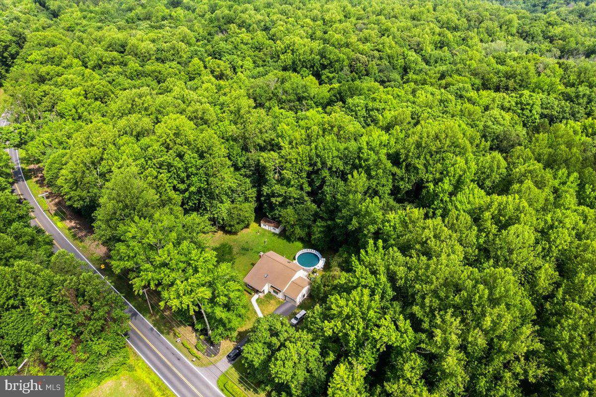 Welcome home to this charming property situated on 3 flat, open acres in the heart of Huntingtown! With plenty of room to spread out both inside and out, this home offers a comfortable layout and great spaces for everyday living and entertaining.
The main level features a bright living room with cathedral ceilings, a separate dining room, and a spacious kitchen that opens to the family room. From there, step out onto the large deck overlooking the above-ground pool—perfect for summer gatherings and relaxing evenings at home. You'll also find a convenient half bath and a large laundry room with its own exterior entrance. New LVP flooring has been installed in the dining room, kitchen, foyer, and bathrooms, adding style and durability throughout these high-traffic areas.
Upstairs, the primary suite includes a private bath, while two additional bedrooms share a full hall bath.
Outside, enjoy the privacy and possibilities that come with 3 usable acres, whether you're gardening, playing, or simply enjoying the open space. Additional features include a one-car garage, an above-ground pool with a new liner and motor, and a fantastic location close to schools, shopping, and everything Huntingtown has to offer. New water softener (Aug 2023), water heater 5/6 years old, inside/outside hvac (Oct 2020), roof 8/10 years old.