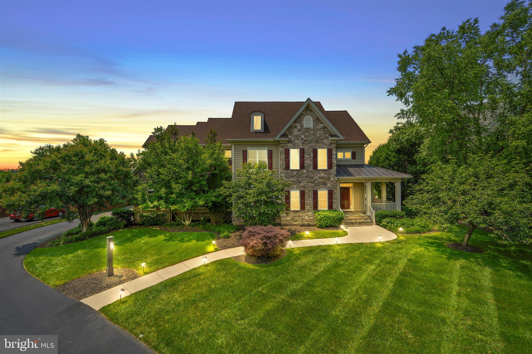 Exceptional Estate Home located in Wild Meadow,  Ashburn Farm’s Best-Kept Secret! Welcome to a truly one-of-a-kind estate nestled in the highly sought-after Wild Meadow enclave of Ashburn Farm. Rarely do homes of this caliber become available in this exclusive neighborhood. This is your chance to own a spectacular property in one of Ashburn’s most coveted communities.   Boasting over 6,100 square feet across three finished levels, this 6-bedroom, 5.5-bathroom home is perfectly positioned on a beautifully manicured, nearly one-acre lot. Surrounded by mature trees and offering a fully fenced rear yard, this property provides breathtaking sunset views and an unparalleled sense of privacy. Exceptional outdoor living designed for year round enjoyment from the heated gunite pool, hot tub and expansive patio to the screened-in porch and composite deck. It encompasses it all to create the ultimate outdoor retreat. Whether relaxing solo or entertaining your friends and family, this backyard paradise is sure to please.  Step inside from the inviting  covered front porch and you'll be immediately impressed by newly installed hardwood floors, custom trim work, fresh paint  and a thoughtfully designed layout. There is so much to love on the main level including recent remodeling to include a  bedroom and full bath making it ideal for a guest suite, nanny quarters, or primary suite option.   Host memorable gatherings in the formal dining room and unwind in the cozy living room or the expansive family room  featuring a gas fireplace and built-ins. The gourmet kitchen is a true showstopper beautifully complete with Granite countertops, subway tile backsplash, Farmhouse sink, center island with prep sink and seating, GE Monogram gas range with center grill, range hood with warming tray, warming drawer, built-in coffee station, and desk area.  Once you've embraced all that the main level offers, take a walk upstairs where you'll find the wide hallways enhance the airy feel. The primary suite is a sanctuary unto itself, complete with a spacious sitting area, two walk-in closets, a private dressing area and an elegant ensuite bathroom.  Also on this level are three additional well sized bedrooms, two full bathrooms, a sunlit open home office with built-ins and a conveniently located laundry room. The daylit lower level of the walk-out basement offers two large recreation areas, a private guest suite with ensuite bath, direct access to the backyard and patio, as well as abundant storage space.
Enjoy all the Ashburn Farm amenities including pools, playgrounds and community events.  Direct access to the W&OD Trail (take the trail/path all the way to Washington, D.C. or Downtown Purcellville).
Located just minutes to the Silver Line Metro, major commuter routes, shops, restaurants  and top-rated Loudoun County schools in a highly sought-after Stone Bridge pyramid.
This exceptional estate blends timeless design with modern amenities, offering both comfort and luxury in a premier location.  Don't miss your chance to own this dream home. Schedule your private tour today!