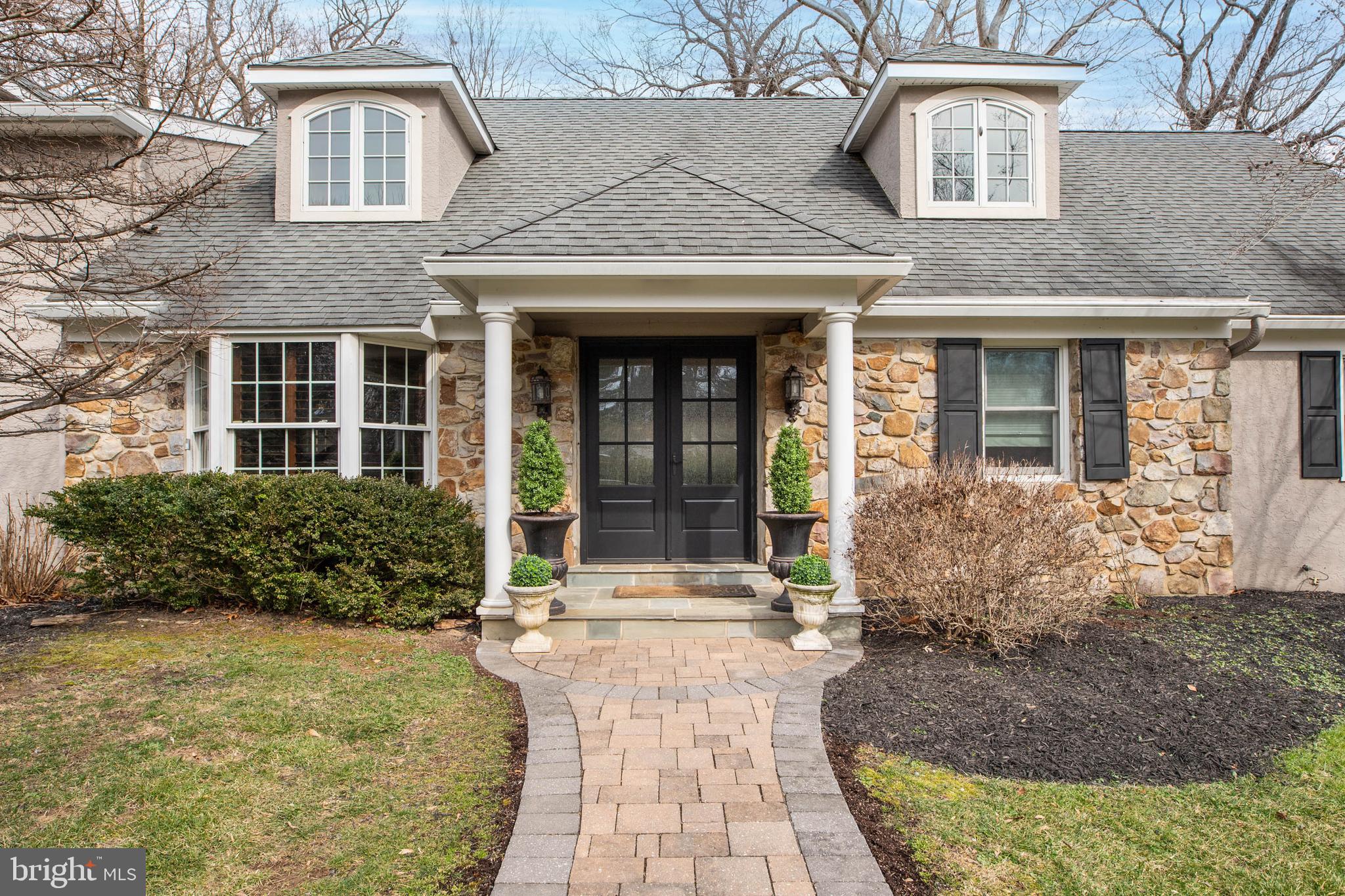 Ideally located at the very end of a quiet, tree-lined cul-de-sac in Tredyffrin Township, this captivating home combines privacy and elegance rarely found. Follow the pathway, surrounded by majestic oak trees and mature, professionally landscaped beds to the double front doors. Admire the dramatic curb appeal in its picturesque park-like setting. Enter the tiled floor center hall foyer. You will immediately notice the luxurious finishes and beautiful flooring throughout. To your left is the handsome office/library with built-in corner cabinets and a window seat. Straight ahead is the spacious living room, resplendent with a wall of windows overlooking the backyard. What a perfect room for large gatherings and entertaining! The formal dining room off the living room easily seats twelve. Your guests will be delighted with this room’s vaulted ceiling and wood-burning fireplace with built-in serving cabinets on each side. A built-in wet bar and a wall of built-in storage/butler’s pantry for dishes, glassware and linen storage are added touches in this fabulous room. These cabinets can be accessed from the kitchen as well. Double French doors open to the incredible flagstone patio. You will feel as though you are at a resort with its outdoor kitchen and expansive yard. How lovely this little retreat is for outdoor dinner parties or an evening glass of wine! Step back inside to the heart of the home. The magnificent kitchen is a chef’s dream. Nothing was spared in designing this room, complete with abundant custom cabinetry, a double Sub Zero refrigerator, Wolf gas range, oven, microwave and warming drawer, a Dacor oven, Sub Zero wine refrigerator, two full sinks, including a porcelain farm sink, 10 foot island and dual pantries. A large family room is adjacent to the kitchen. Whether you are hosting a party or enjoying a tv night at home with family, this comfortable room is ideal.  Three French doors in this room open to a courtyard, a perfect spot for an herb garden, another grilling area or a morning cup of coffee! The laundry room and mudroom can be found off the kitchen. You will be amazed by all the closets and cabinets for storage and cubbies for placement of coats/shoes, sports gear, and backpacks. A back door leads to the driveway, backyard and three car garage. There is a back staircase for convenience to the second floor. A double coat closet and powder room is located on the first floor, as well as an in-law/au pair/guest suite, with a sitting area, a huge walk-in closet/dressing area and an ensuite bathroom with a tub. Upstairs to the left is the luxurious primary suite with an ensuite bathroom, sitting area, three walk-in closets with built-ins by California Closets and a French door leading to an outdoor balcony. Another laundry area is located outside the suite. Two other generously sized bedrooms, each with ensuite bathrooms, are on the second floor. Both contain walk-in closets, built-in desks and storage cabinets. A sitting area in the hallway is a cozy spot for reading. Not to be missed is the basement. Down the stairs and to your right is the utility room with a work bench and more storage space. To your left is another bedroom/office and a full bathroom with a shower. A custom wine cellar which holds 1200 bottles of wine will be the envy of every wine collector. Continue down the hall to the tv area, pool table, wet bar with a beverage refrigerator and a sliding door to the second patio overlooking the backyard. There is plenty of room for exercise equipment and/or play space for children. The prime location of this home is close to the Radnor train station, major commuting routes, shopping, restaurants, medical centers and award-winning schools. Do not miss the opportunity to see this special home today!