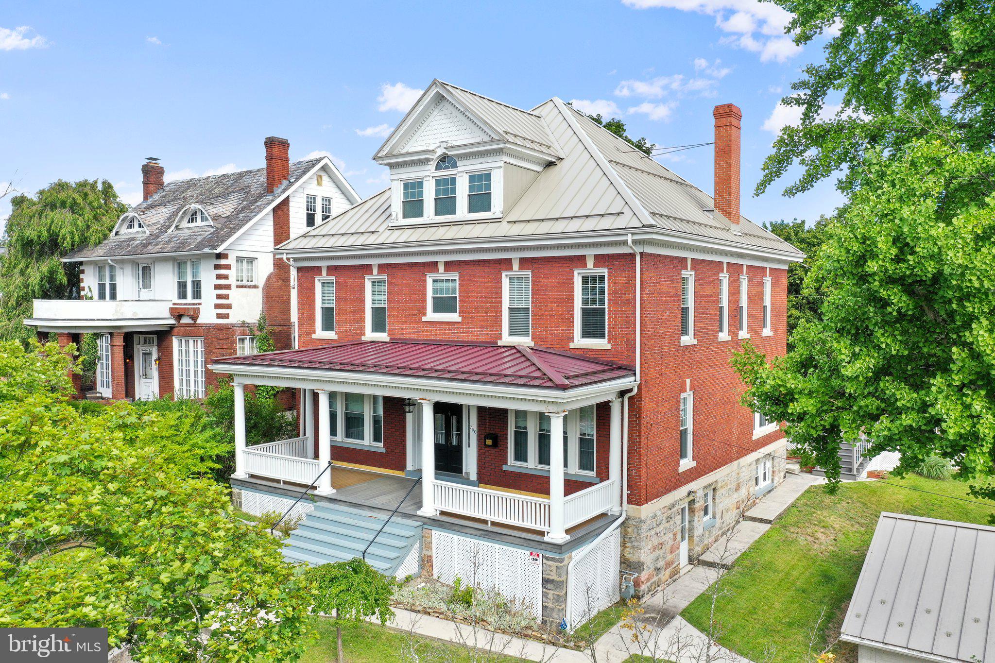 Ready to be HOME for the Holidays??  Grand brick home on Washington Street with tons of updates including a new boiler furnace! Elegant at its BEST!!  Situated on .32 of an acre with 4-5 bedrooms, 3 full baths and 1 half bath, with jaw breaking views from every angle!  This home boost over 3,500 sq ft with 4 finished levels on a double lot.  Fill the whole wish list on this prestigious home! Enter from Washington Street to a large front porch from sipping on coffee to entering into the eminence front.  Take in the beautiful architecture while deciding which way to go first.  10 foot ceilings throughout. Natural gas steam heat. WHOLE  house generator too!! To the left, the living room is delightful filled with lots of windows for sunlight and entertaining space.  The second living room has a fireplace for cold days and gatherings. Enter into the dining room, enjoy the views and second fireplace.  Beautiful hardwood through the whole house.  The galley kitchen (2nd kitchen) is right off the dining room with a lot of storage.  The main kitchen follows with a second dishwasher, microwave, refrigerator, gas stove and double oven. Tons of counterspace including the middle counter with large sink.   Every detail counts!  WOW! Half bath on first floor.  2nd floor which has two staircases depending which way you would like to go from the kitchen or from the grand entrance. Get ready! 4 bedrooms with 3 full baths and laundry.  Did you see that bathtub?! Enjoy relaxing bubble baths.  3rd floor is a must see! All open for you to use your imagination. gym, museum, recreation room, suite.. you decide.   The basement has another recreation room with entrance and another laundry area and workshop area.  Large, oversized garage with tons of storage.  VIEWS at the BEST!  Enjoy sunsets and gathering on your large deck attached to the back entrance and sunroom. Central air and generator.  Lots of covered off-street parking in back including double carport. Close to Interstate 68 for commutes.  1 hour from Hagerstown, MD and 10 minutes to PA line.  Washington Street is waiting for you to see the magnificence and pride that the ownership has gone into this gem over the years.  Ready to call this outstanding, beautiful 1920's historical brick home YOUR new home?