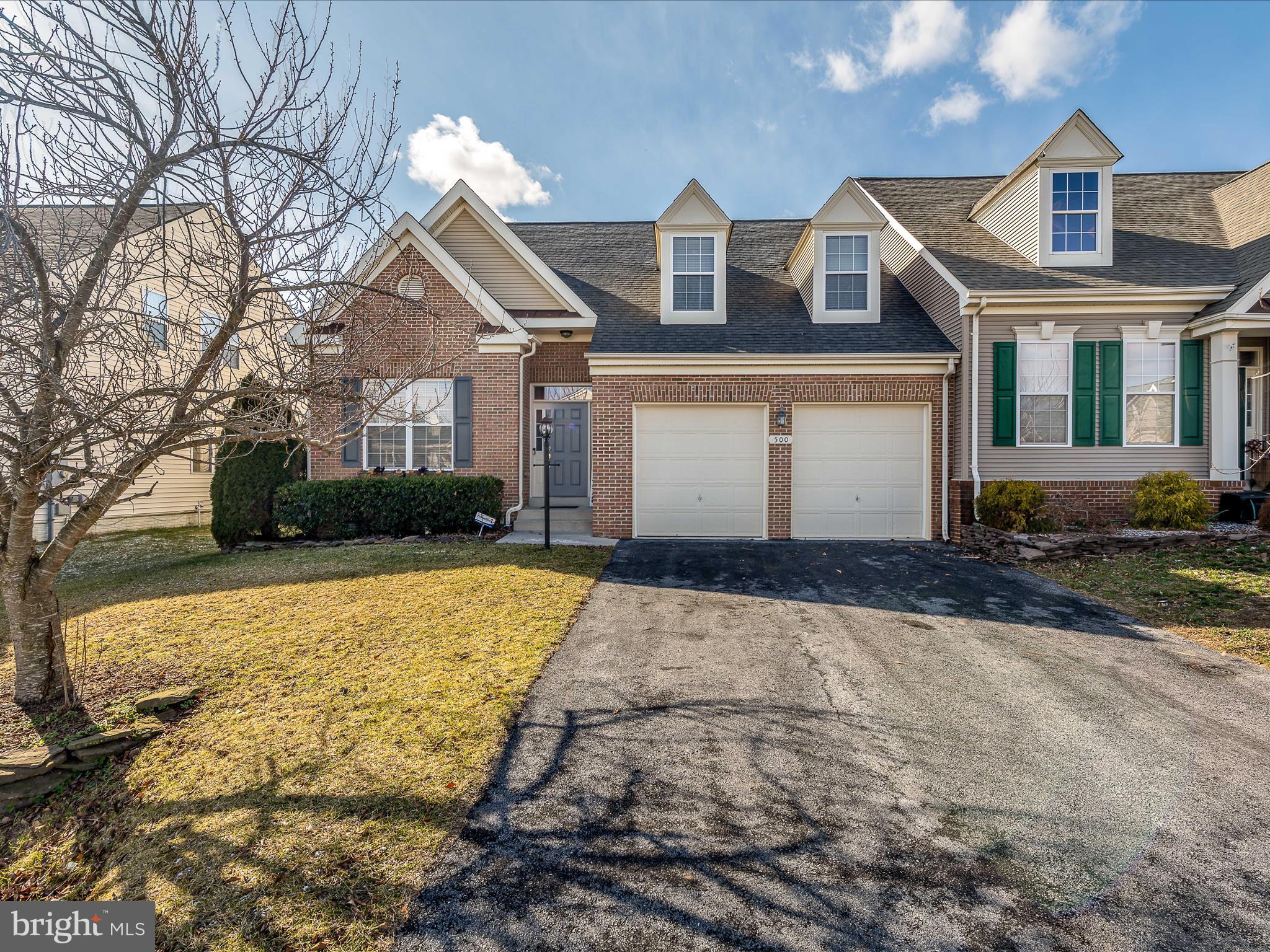 This lovely, brickfront villa features 4 bedrooms and 3 full baths. The home is situated in the much sought after Hammonds Mill neighborhood. Upon pulling up to the home you notice the well manicured front lawn and tons of curb appeal. The long driveway affords 4 off street parking spots on top of those in your 2 car, attached garage. Your 2 car garage features  a freshly painted floor and keeps your cars and you out of the weather. Inside you have a bright, welcoming foyer with hardwood floors and beautiful craftsman trim detailing. To your right you have direct access to the 2 car garage. To your right is main level bedroom 1. Bedroom 1 features tons of natural light and carpeting. The double closet affords plenty of storage space. The ensuite bathroom features dual entry from the main hallway. Bathroom 1 has ceramic tile floors, a 3 ft single bowl vanity, and 5 ft tub/shower with tile surround. Continuing down the main hall you see your staircase to the upper level accented with shiplap detail. The large laundry room features easy care, vinyl floors and shelving storage. The laundry machines and 80 gallon water heater convey. Beyond this the dining room features hardwood floors and decorative light fixture. The space is open to the kitchen and living room, great for entertaining. Hardwood floors continue into the spacious kitchen. Here you have updated stainless steel appliances and the dream, stainless farm sink. The maple stained cabinets are accented with beautiful, brand new quartz countertops. You have a large pantry for plenty of extra storage. The kitchen leads into your breakfast room. The breakfast room features tons of windows for natural light and decorative light fixture to define the space. This space features access to your rear deck. Beyond the kitchen and breakfast room you have your large living room. Hardwoods continue through here as well. There is recessed lighting in addition to the lovely ceiling fan. Finally, you have a far fireplace with mantle and shiplap accent. This will keep you cozy in these winter months. Across from the dining room you find yourself in the dreamy primary suite. You have those lovely hardwood floors again, with a wall of windows and glass door for private access to the rear deck. The space features unique, wall trim detail and ceiling fan. The suite includes a private ensuite bathroom. The primary bath features ceramic tile floors and double pedestal sinks. The 5 ft walk-in shower with tile surround and seat is perfect for those busy mornings. Then, after a long day, you can relax in your 5 ft soaking tub with tile surround. Your suite is topped off with a large walk-in closet with built-in shelving. You will want for nothing in this perfect space. Upstairs you have a large, carpeted loft with closet storage. This could be a great WFH space. Bedrooms 3 and 4 feature carpet, ample closet space, and lovely dormer windows. The upper level bathroom features ceramic tile floors and 5 ft tub/shower with tile surround and shelf. You will have plenty of storage in the 3 ft single bowl vanity. Outside the home you have a large rear deck, perfect for hosting in the warmer months. Stairs walk down to the concrete patio. Beyond this you have a grassy, fully fenced rear yard. Bring the pups! This home has everything you want and more! Call for your showing before it's gone!