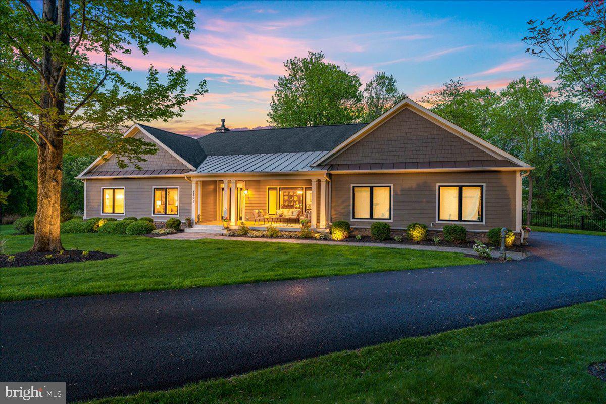 Set on over three private acres and thoughtfully custom-built, this exceptional ranch-style home represents one of the most desirable settings you’ll find in Frederick County. Combining refined design, quality craftsmanship, and true one-level living, the property offers a rare balance of privacy, comfort, and natural beauty. Energy-efficient features, including geothermal systems, further enhance the home’s forward-thinking design.

Inside, the main level is finished with hardwood flooring throughout and designed to accommodate both everyday living and effortless entertaining. The open-concept kitchen is a standout, featuring premium appliances such as a wall oven, six-burner cooktop, abundant cabinetry, and a generous center island. It flows naturally into a casual dining space, which opens to a stunning screened porch, perfect for enjoying the outdoors in comfort.

The adjacent family room features a gas fireplace as its focal point and extends out to a flagstone deck that overlooks the beautifully landscaped grounds, creating a seamless connection between indoor and outdoor living.

The primary suite is privately situated in its own wing of the home and showcases expansive windows on two sides, framing some of the best views on the property. The spa-inspired en-suite bath includes a large walk-in shower, dual vanity, and elegant tile work, along with a dedicated dressing area and custom closet systems.

On the opposite wing, you’ll find two additional bedrooms and a beautifully appointed hall bath with upscale finishes. Additional main-level spaces include a formal dining room overlooking the front yard, a comfortable sitting room ideal for reading or relaxing, as well as a laundry room, mudroom, and powder room.

The lower level spans the full footprint of the home and offers exceptional flexibility, with potential for expanded living space, recreation areas, additional bathroom, or additional bedrooms. With a six-bedroom perc in place, egress windows, rough-in plumbing, and walk-out access to the side yard, the layout is already well-suited for future finishing. High ceilings add to the sense of openness and possibility.

The home includes an oversized garage with epoxy-coated floors, which is a sought after ammenity.  low maintenance and a vast space for storage, hobbies, and utility! 

Carefully maintained and beautifully executed, this home reflects true pride of ownership throughout. With its thoughtful layout, quality finishes, and effortless livability, it offers a rare opportunity to own a property that feels both refined and comfortable. Recent updates include professionally designed landscaping enhanced by a comprehensive outdoor lighting package, creating a beautifully illuminated setting after sunset.  Custom-style black aluminum fence surrounds the rear yard, offering a classic architectural detail that blends seamlessly with the outdoor setting. A freshly painted interior paired with custom-designed molding details throughout creates a polished and cohesive aesthetic.  Ideally located just minutes from downtown Frederick while still enjoying the benefit of no city taxes, this is a special offering in an exceptional setting. A home like this doesn’t come along often!