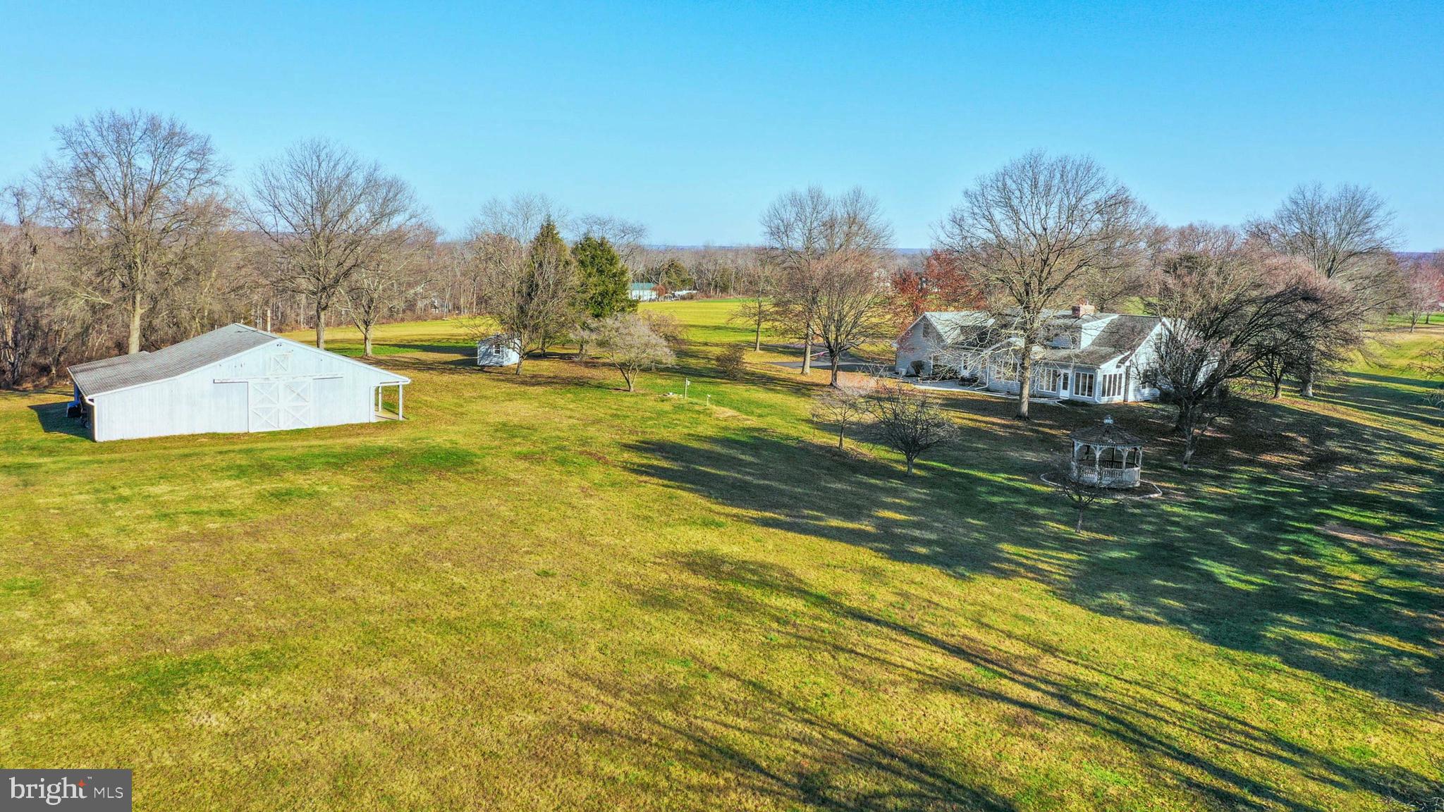 Set back on over twelve acres down a tree-lined drive, Meadow Spring Farm combines complete privacy, wide open skies and a multitude of amenities for luxurious country living.

Built in 1987 by Richard Zaveta, the cape cod-style residence features gleaming hardwood floors in the main living spaces, large windows, and two wood-burning fireplaces. A sunroom, family room with built-ins, and well-equipped kitchen overlook the peaceful surroundings. Four sunny and spacious bedrooms include a first-floor primary suite with walk-in closet and jetted tub, along with two upstairs bedrooms and a bonus private suite. Enjoy quiet evenings outside on the paver patio or in the quaint gazebo. New carpet, refinished floors, and an attached 2-car garage are welcome amenities.

Steps away, a charming barn in excellent condition has four stalls, a workshop, storage areas and two tractor bays. Located within the Pennridge School District and just a few minutes away from Nockamixon State Park, this turnkey property blends country living with quick access to Doylestown, the Lehigh Valley and New Jersey just across the Delaware River.