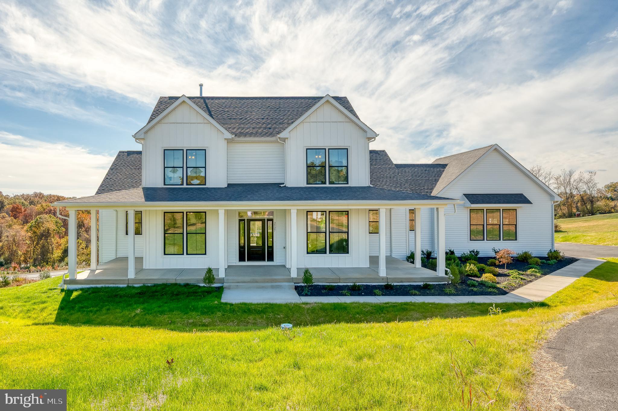 Brand New & Move-In Ready! Welcome to the Georgia Model by Greenspring Homes in Shamrock Estates, perfectly situated on nearly 2 private acres. Enter the home from the full wrap-around covered front porch. This beautifully designed space features 4 bedrooms and 3 full baths, including a main-level primary suite with a spa-inspired bath and walk-in closet. Enjoy beautiful engineered hardwood floors, a formal dining room, butler's pantry, spacious family room with gas fireplace, and a gourmet kitchen with quartz countertops, stainless steel appliances, expansive center island, and walk-in pantry. Upstairs offers 2 additional bedrooms and another full bath. The light-filled, walkout lower level includes a finished recreation room, bedroom, and full bath, providing even more living space (check back for additional photos). Quality craftsmanship, modern finishes, and peaceful surroundings make this home a must-see!